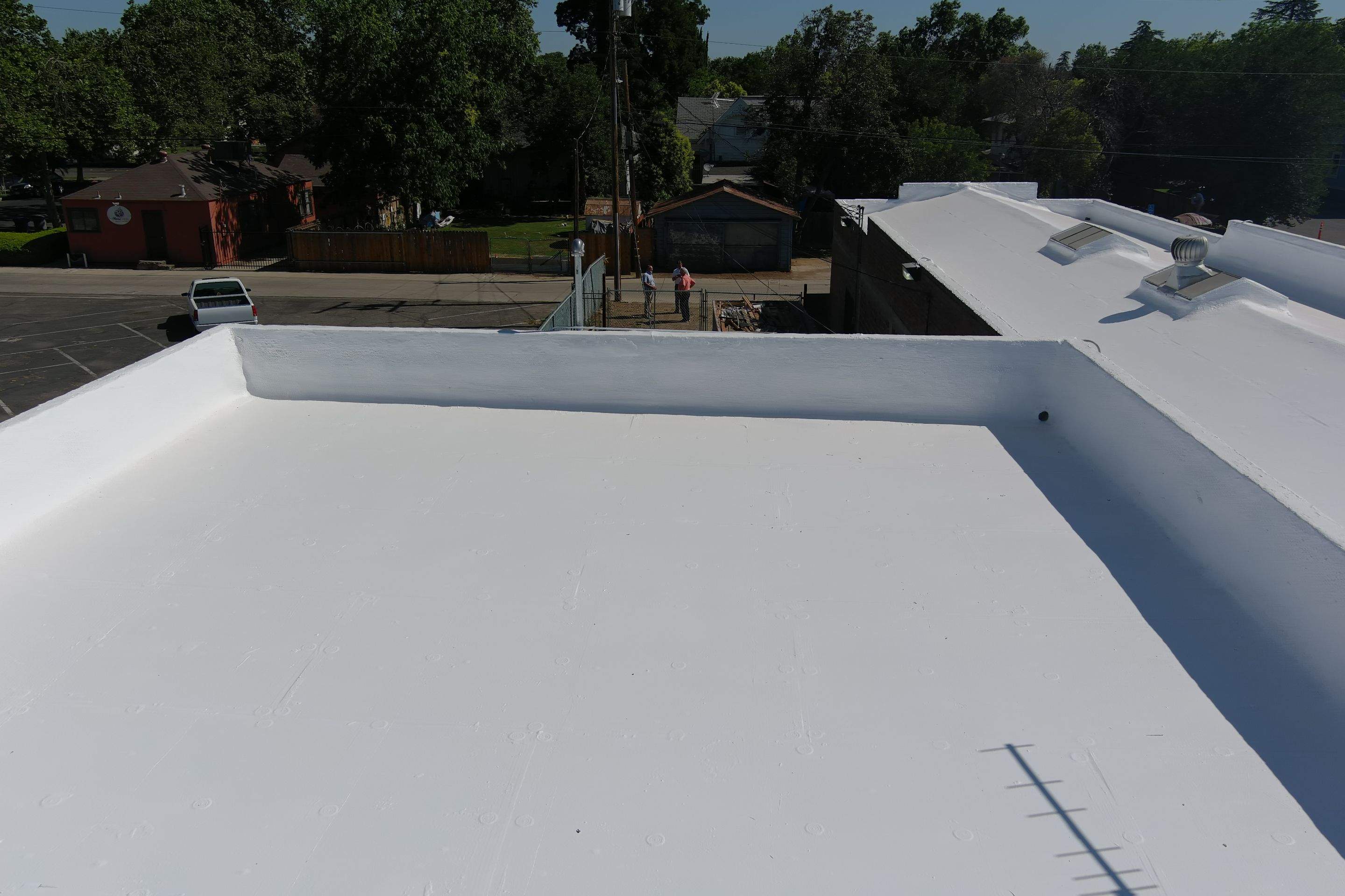 Commercial Roofing Installation using Conklin BenchPly system with PUMA top coat (imbedded fabric system) by Straight Edge Roofing Inc