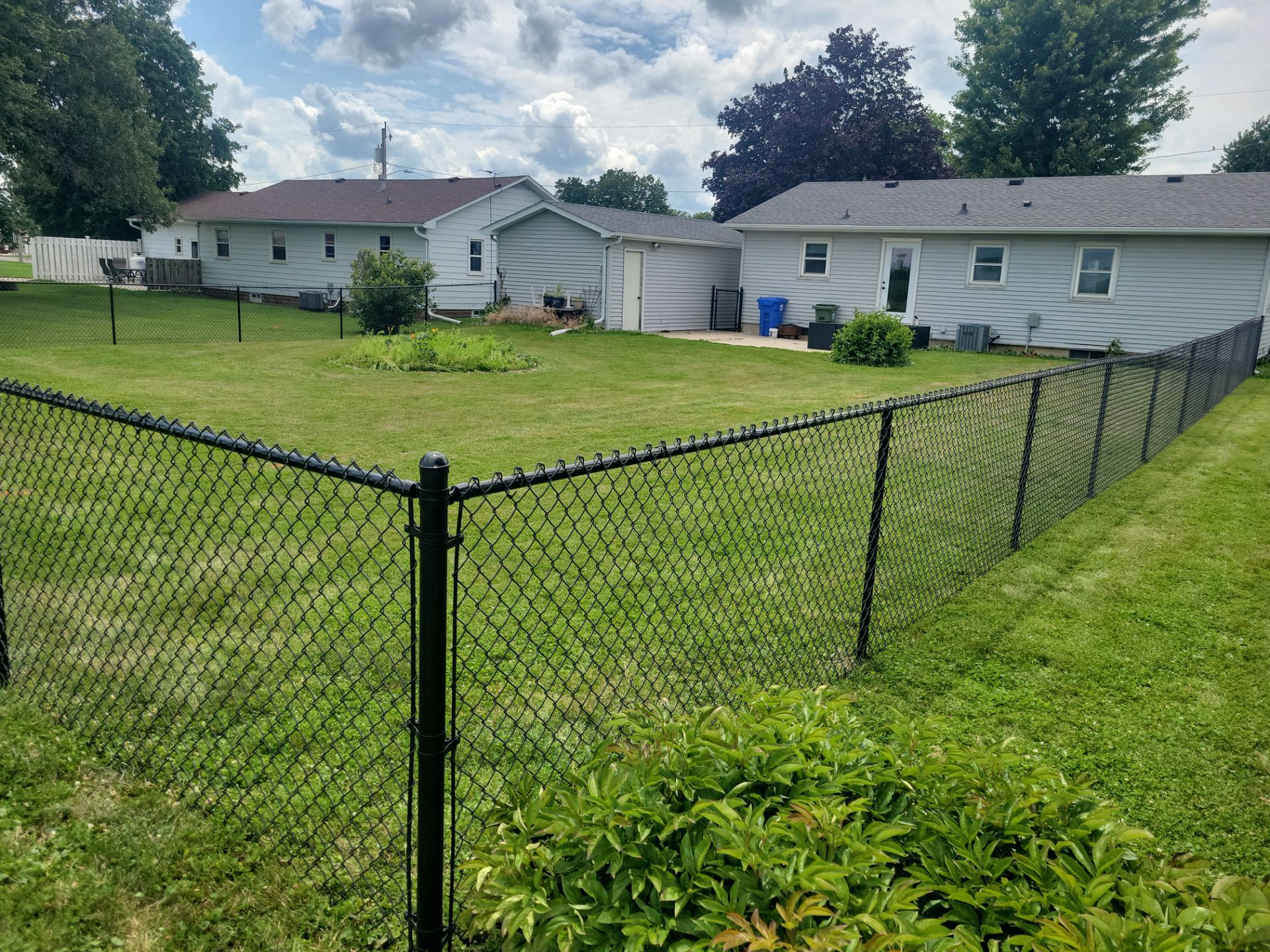 Residential Black Vinyl-Coated Chain Link Fence Installation in Allison by Perfect Picket Fence and Stain