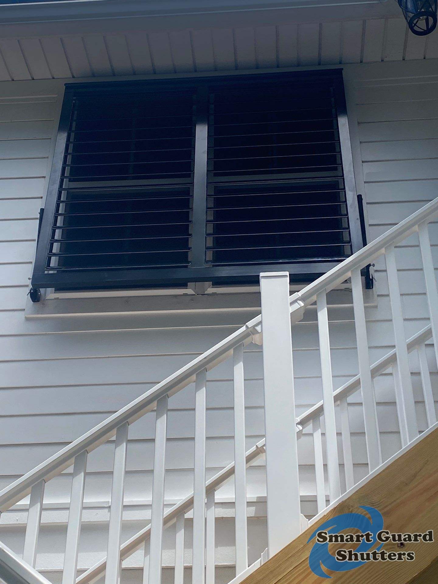 Impact Bahama Shutters in Jet Black by Smart Guard Shutters
