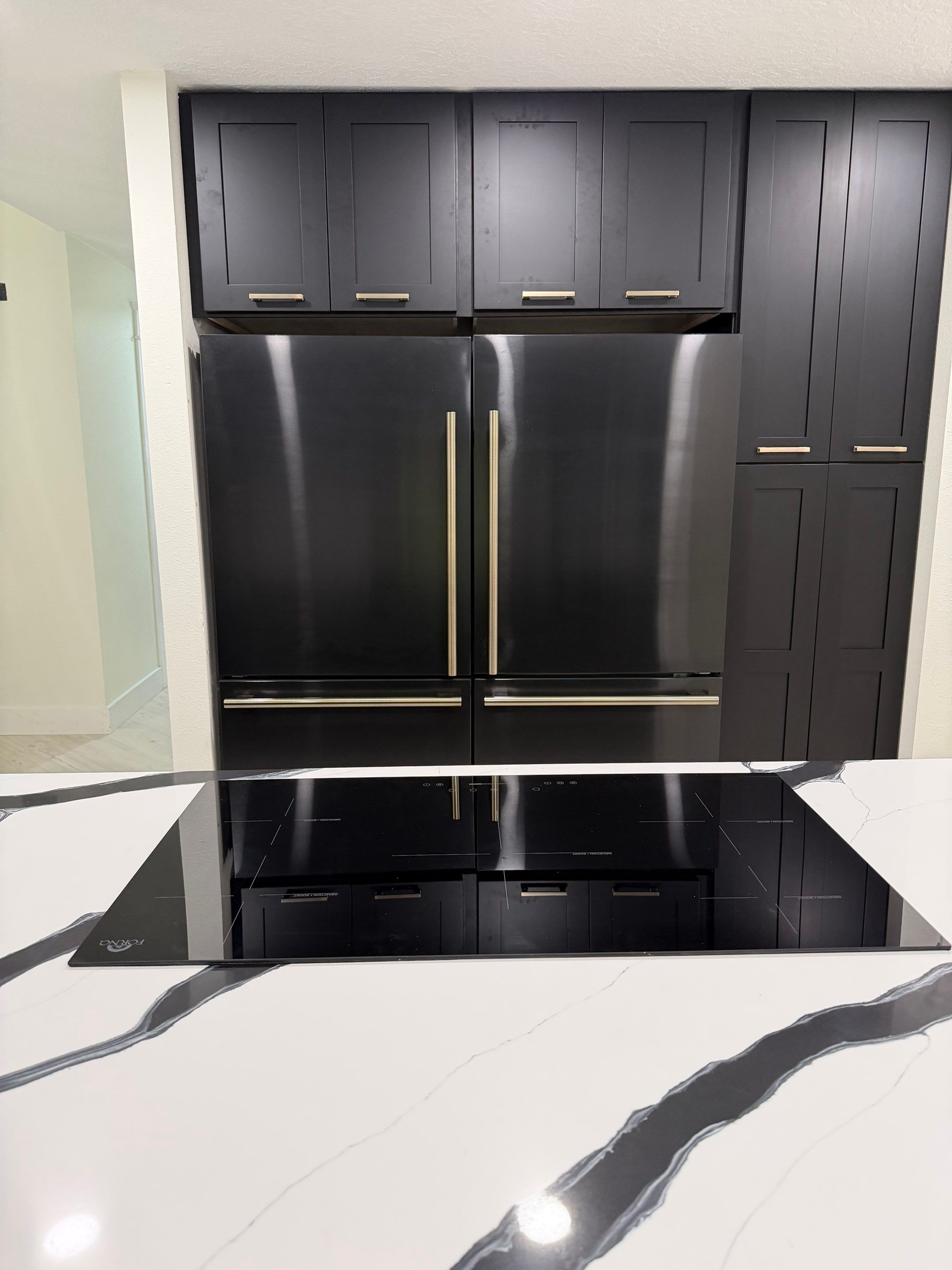Modern Kitchen Remodel in Port Orange Featuring Waterfall Quartz Island by Acies Renovations