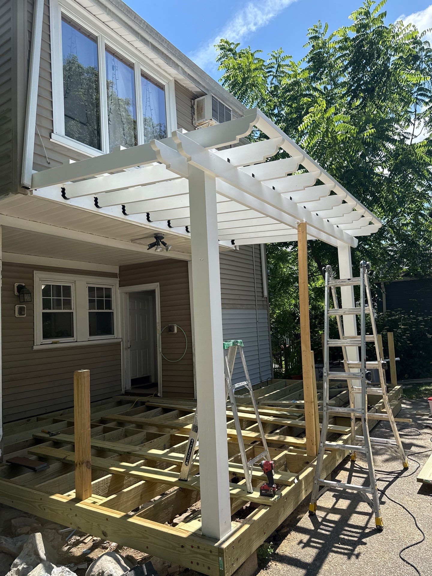 new deck with custom pergola by CabralCarpentry & Painting LLC