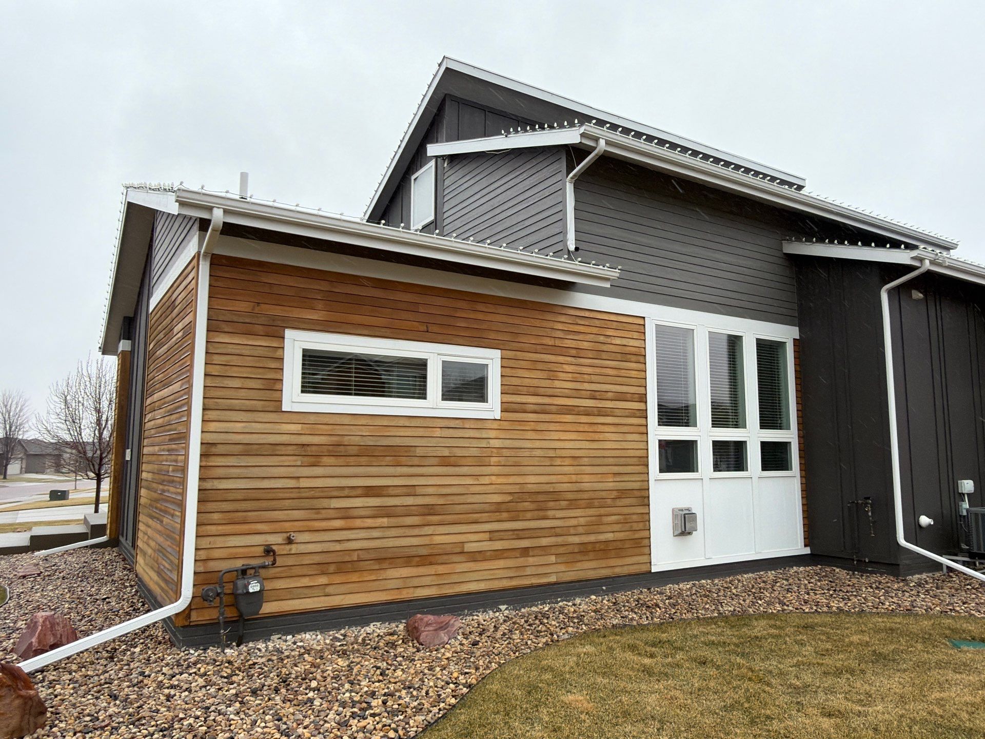 Modern Exterior Transformation Featuring Dark Board and Batten Siding in Sioux Falls by Select Painting, Coatings & Garage Cabinets
