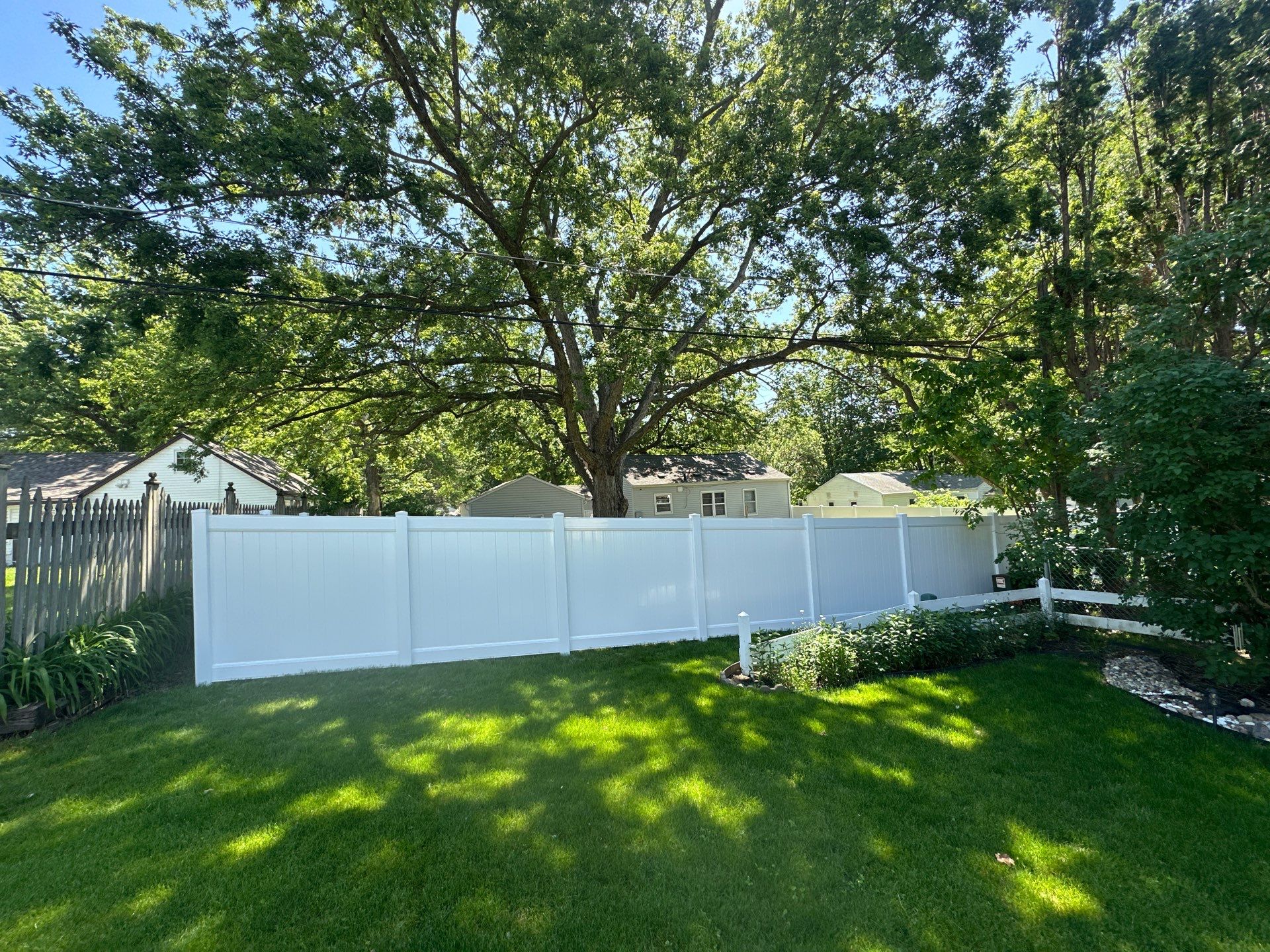 White Vinyl Privacy Fence and Double Gate Installation in Cedar Falls by Perfect Picket Fence and Stain