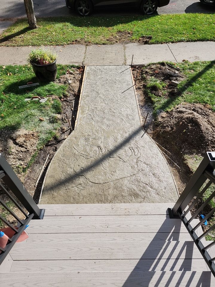 Exterior Renovations- Siding, Stamped Concrete, Porch, and Railings by Ivy Lea Construction