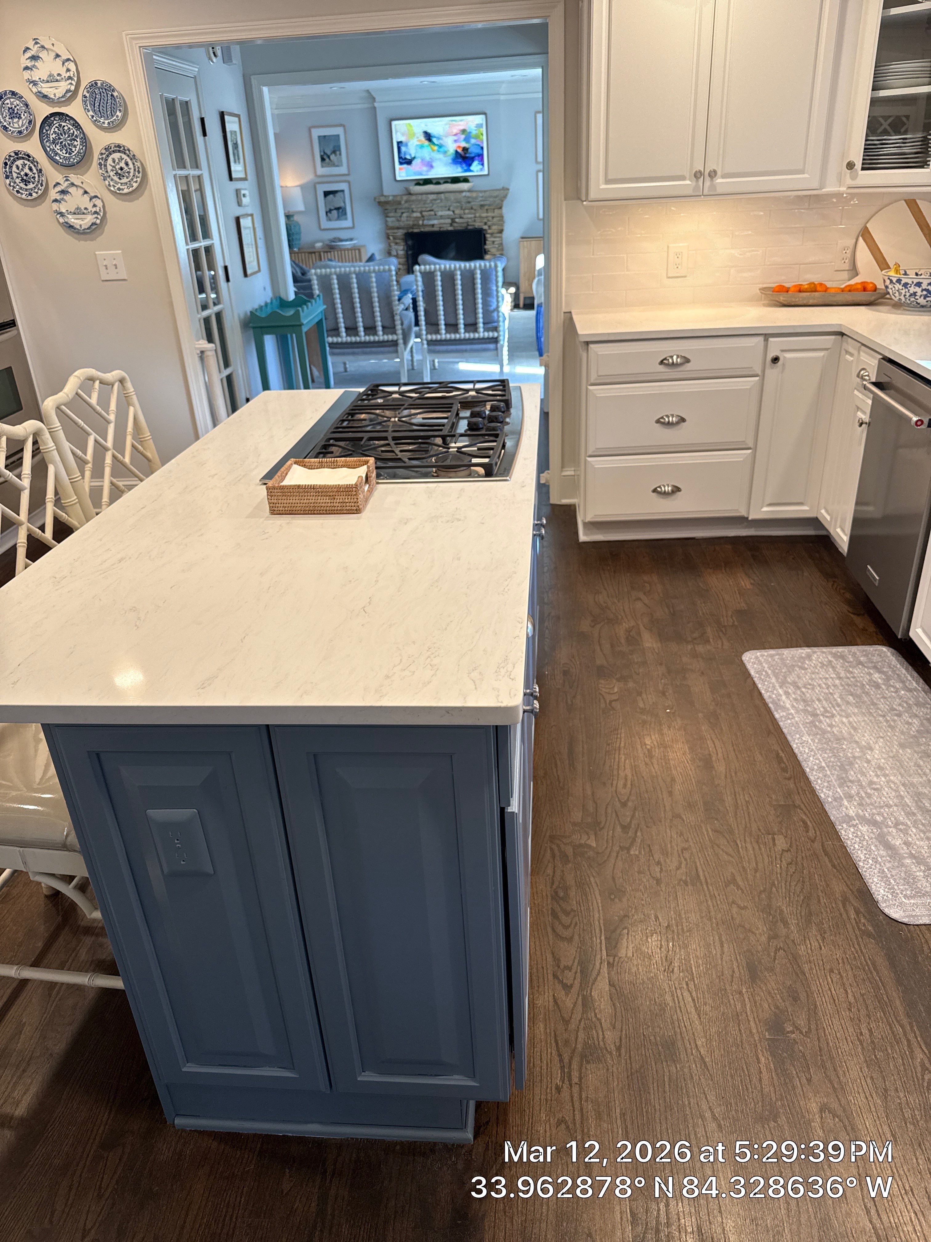 Kitchen Remodel in Dunwoody Featuring White Cabinetry and Blue Island by Heart & Home Kitchen & Bath Remodeling LLC