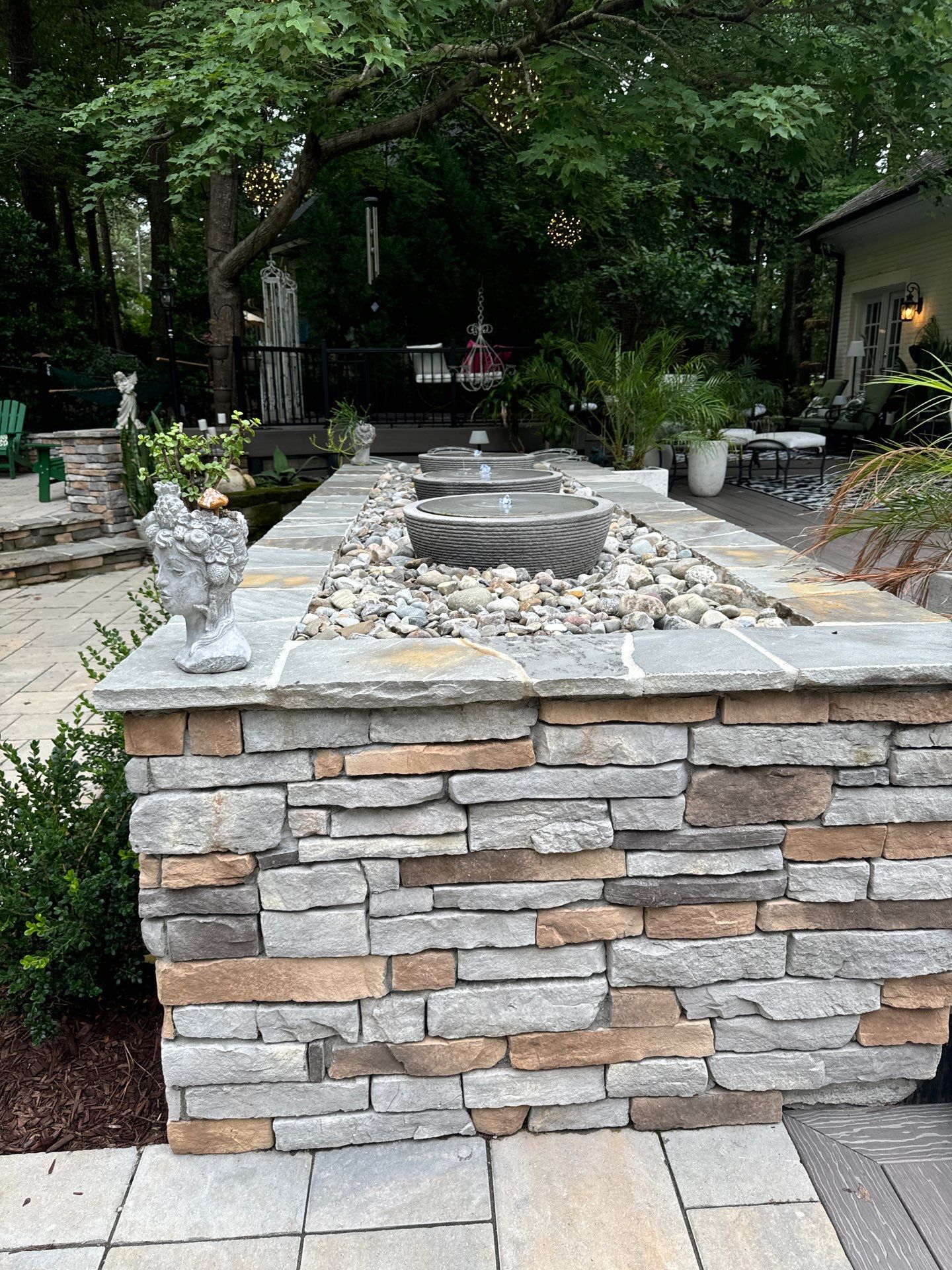 New Deck, Stone Fountain Feature, Circle Stone Sitting Area with Fireplace by The Remodeling Company