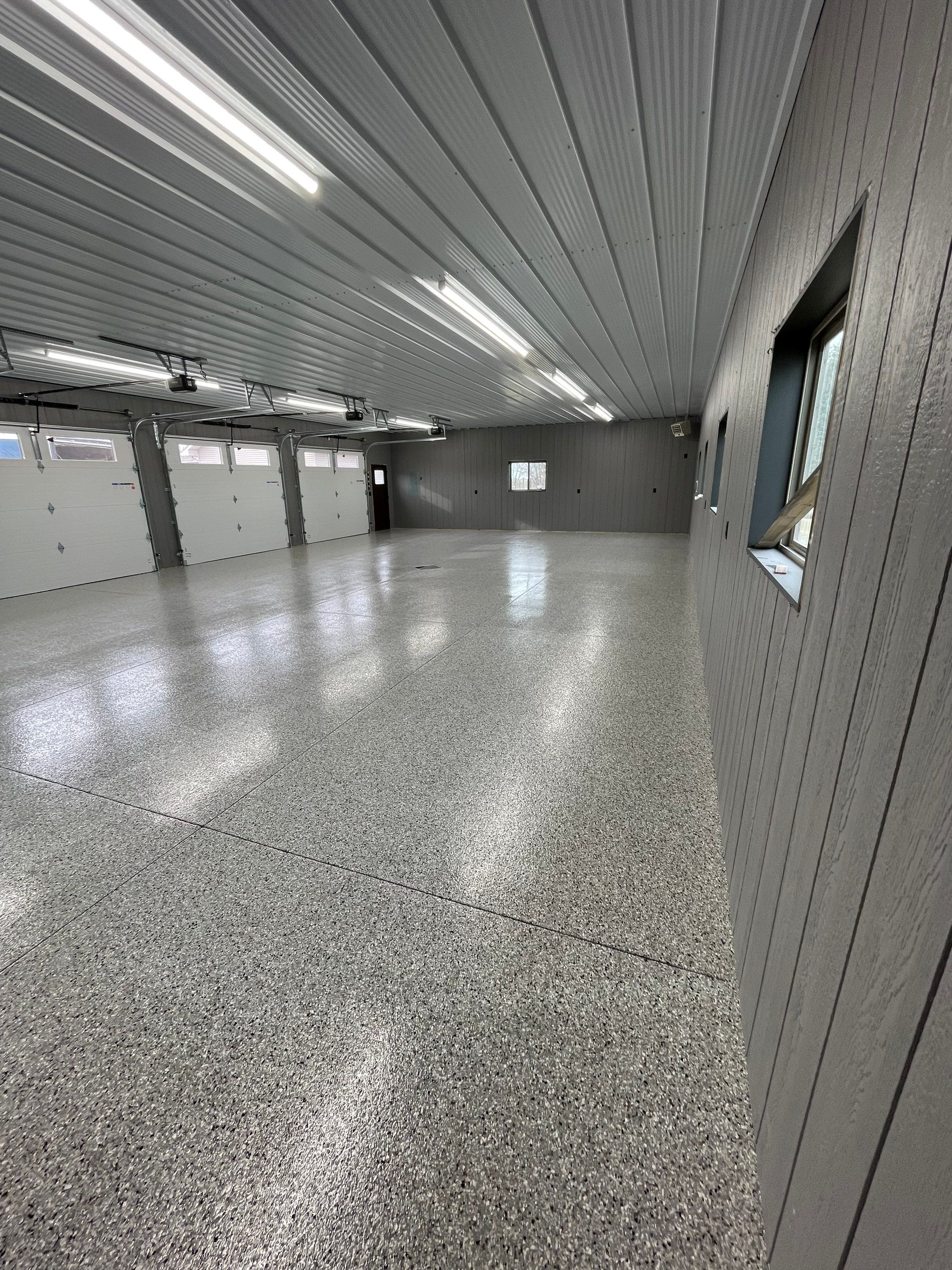 Speckled Epoxy Floor Coating for Large Shop in Rock Valley by Select Painting, Coatings & Garage Cabinets