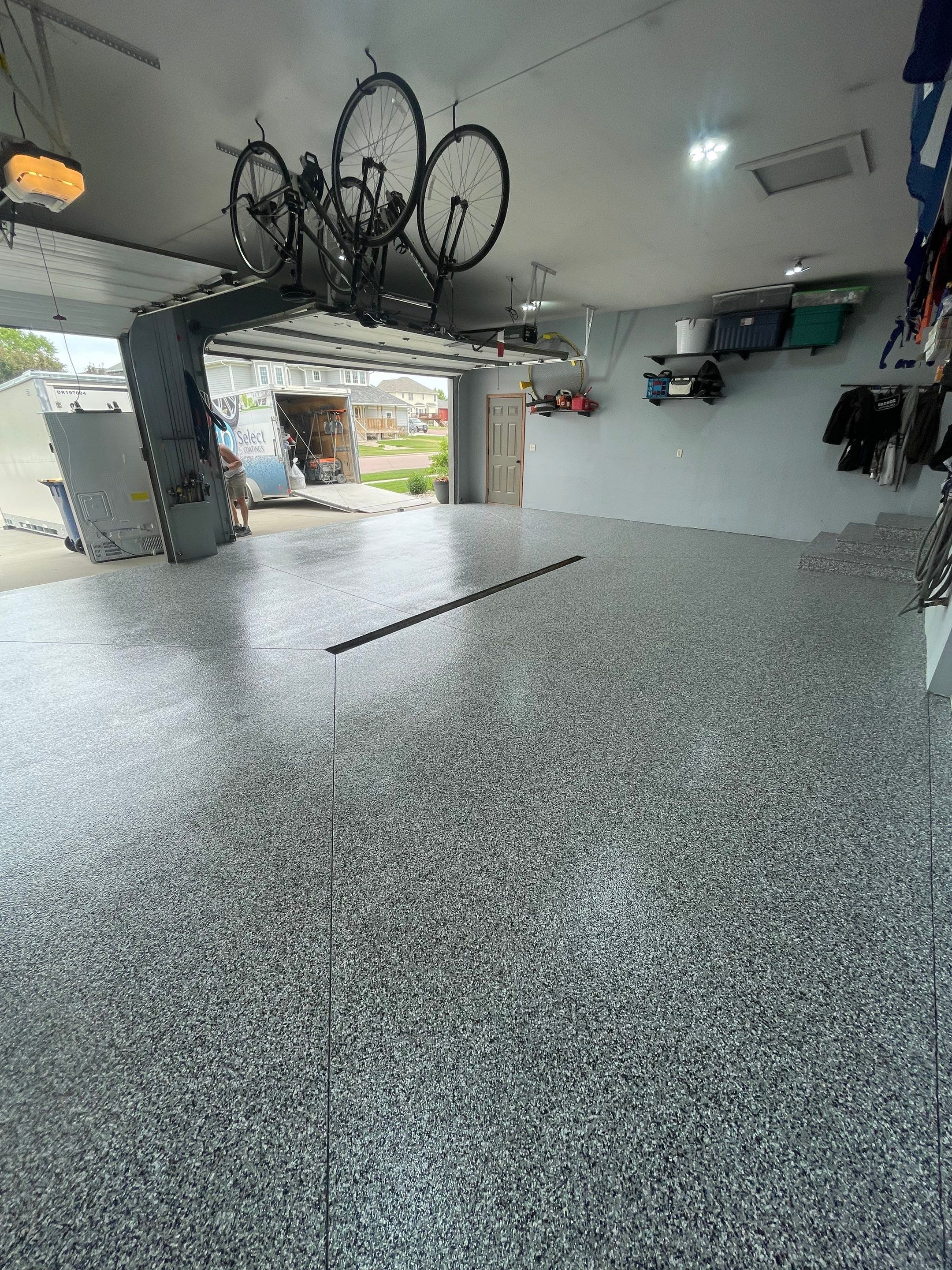 Full Garage Floor Epoxy Coating Installation in Dell Rapids by Select Painting, Coatings & Garage Cabinets
