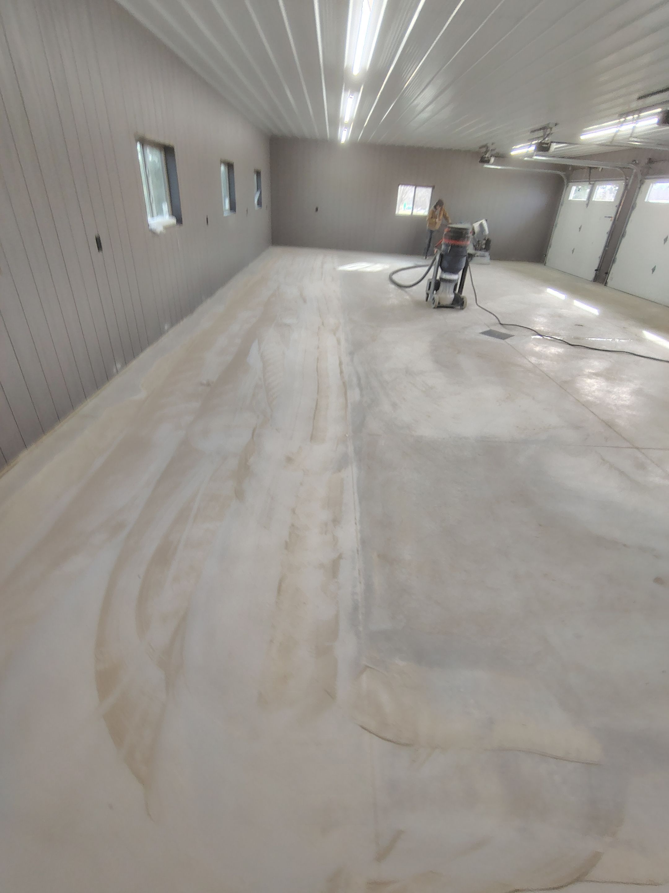Speckled Epoxy Floor Coating for Large Shop in Rock Valley by Select Painting, Coatings & Garage Cabinets