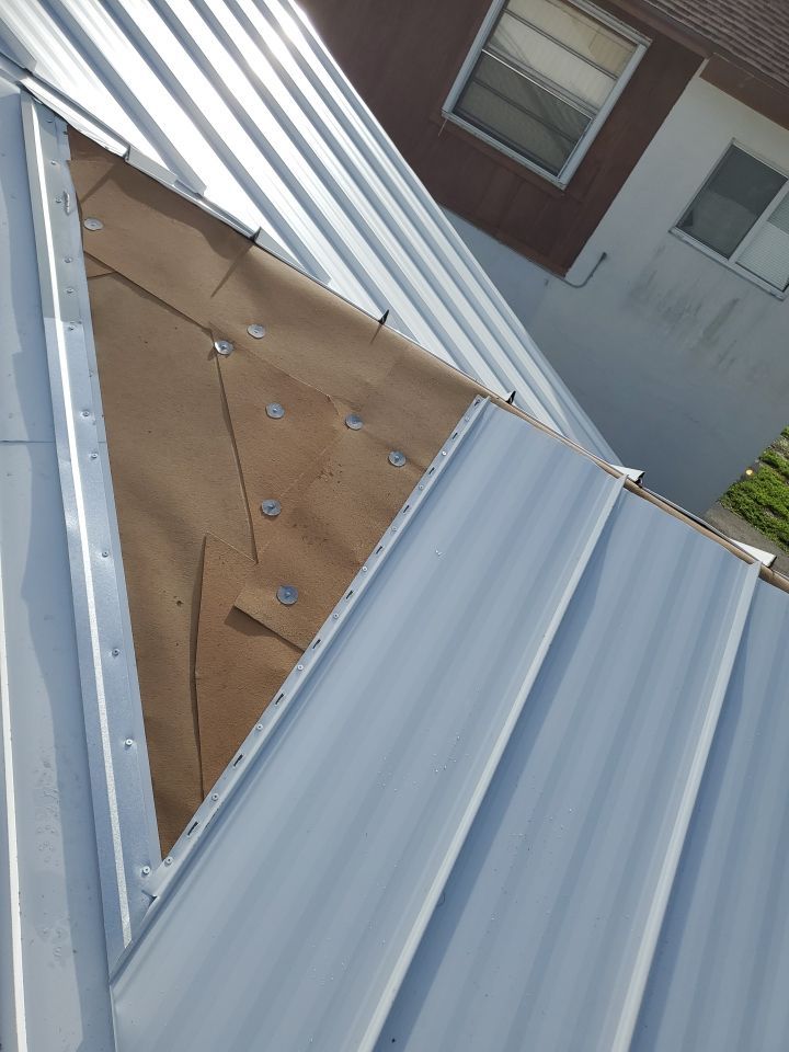 Residential Roofing Installation using 1.5" Nail Strip 24ga Solar White Kynar Coated Standing Seam Metal Panels by Morton Roofing, Inc.