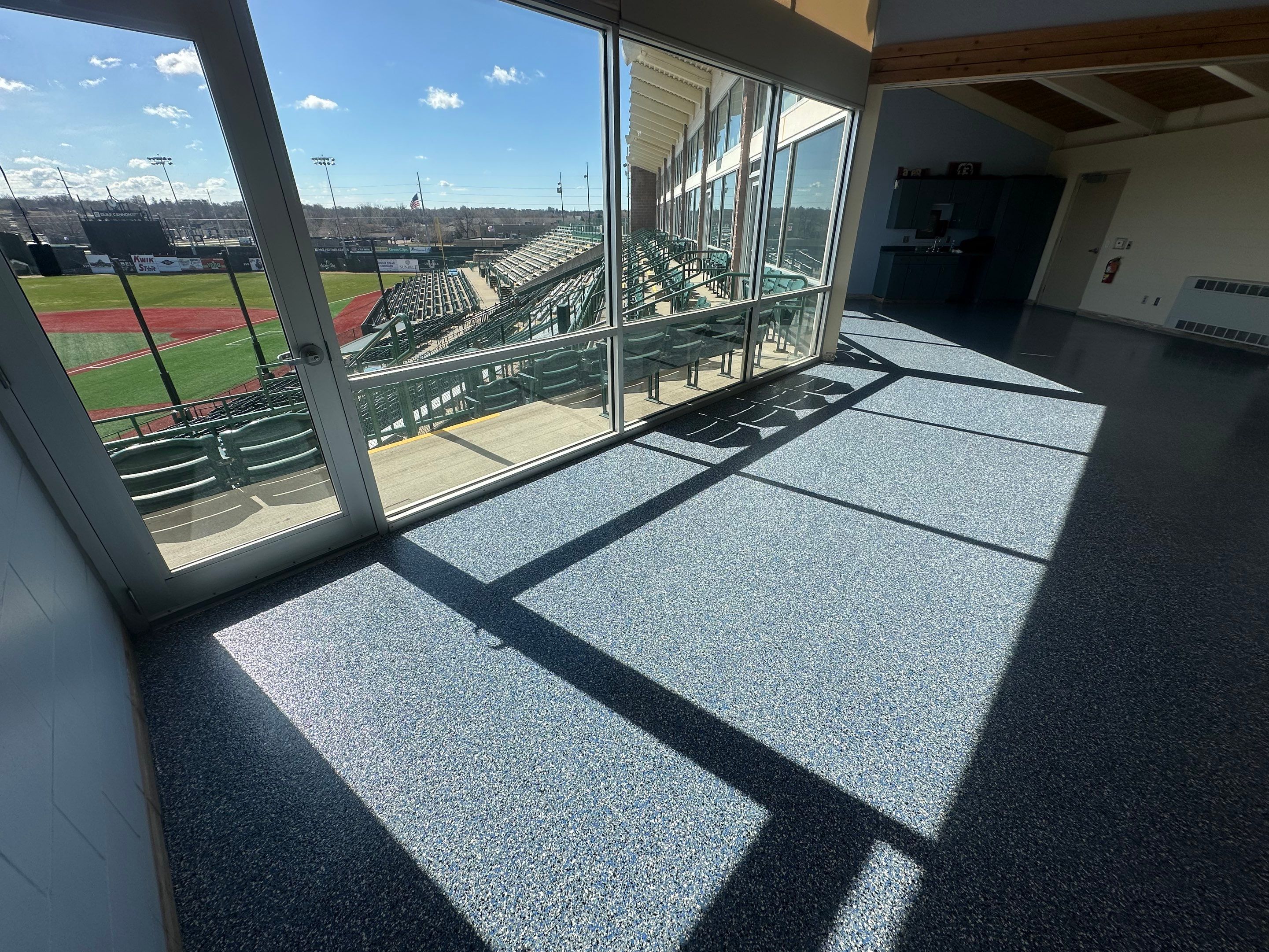 Commercial Epoxy Floor Coating for Stadium Viewing Suites in Sioux Falls by Select Painting, Coatings & Garage Cabinets