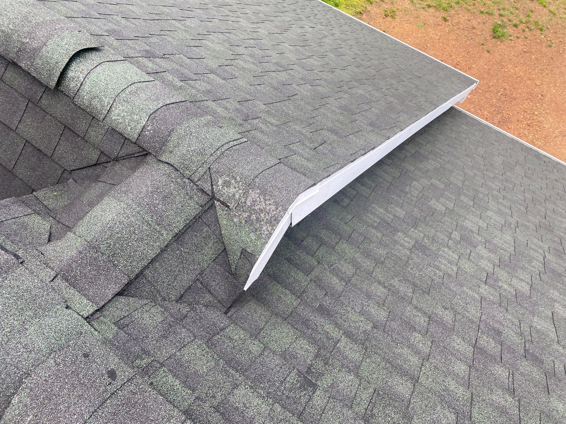 Green Metal Roof and Custom Covered Deck in Duncannon by Esh Builders