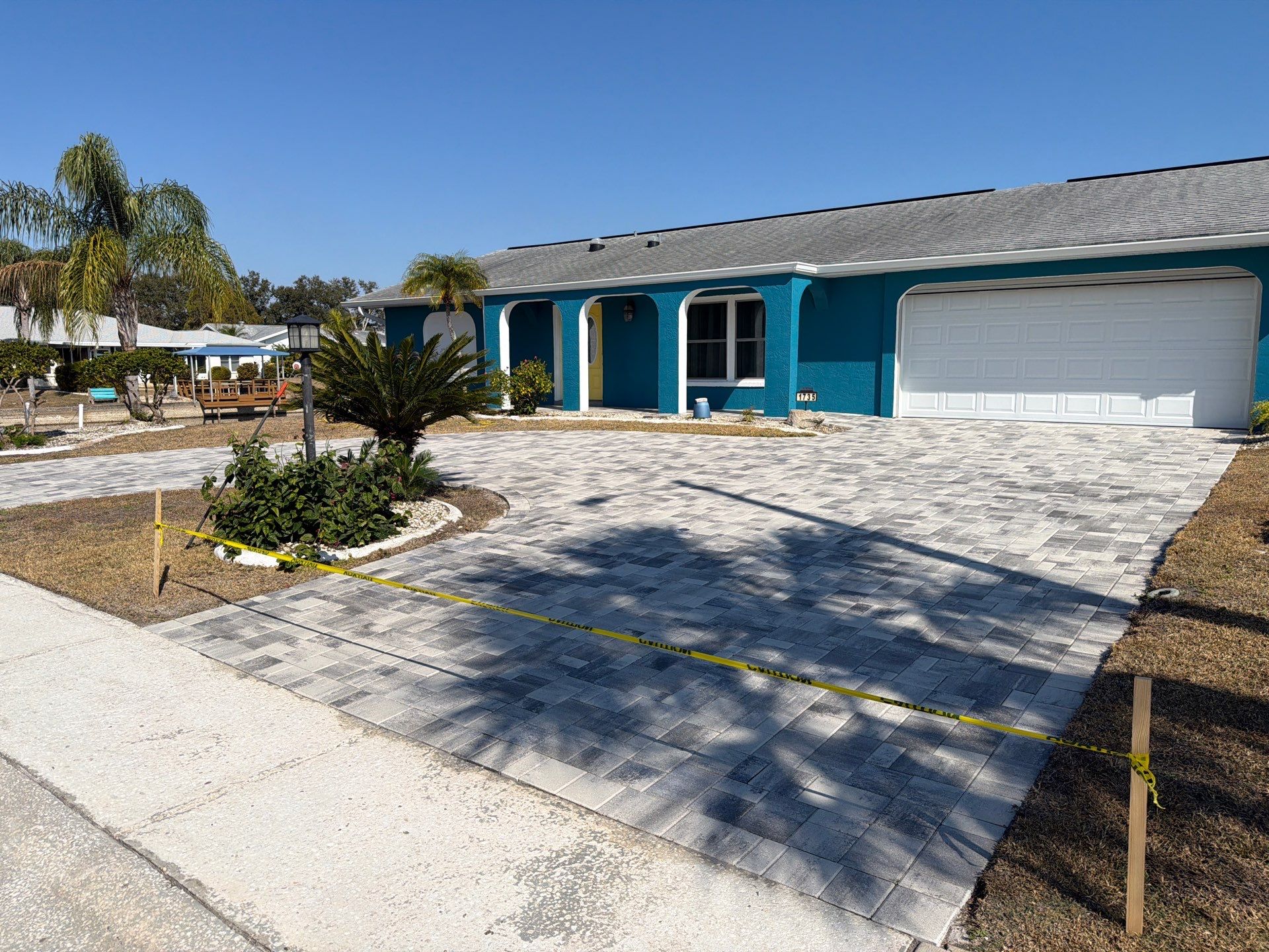 Modern Gray Paver Driveway and Entryway Walkway in Sun City Center by Supreme Paver Experts