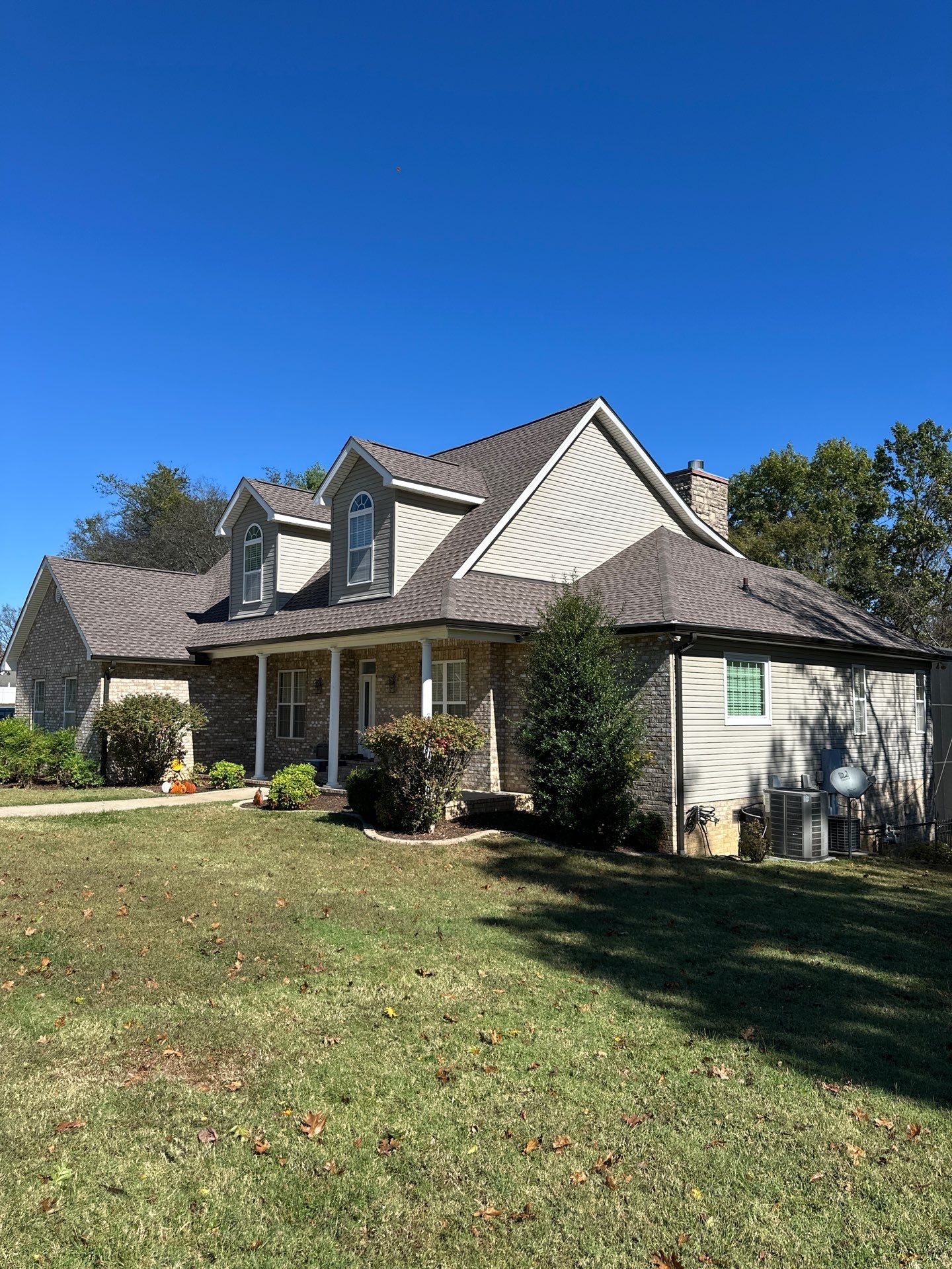 Roof and Gutter System Replacement with Stone Chimney Rebuild by Undersun Roofing 