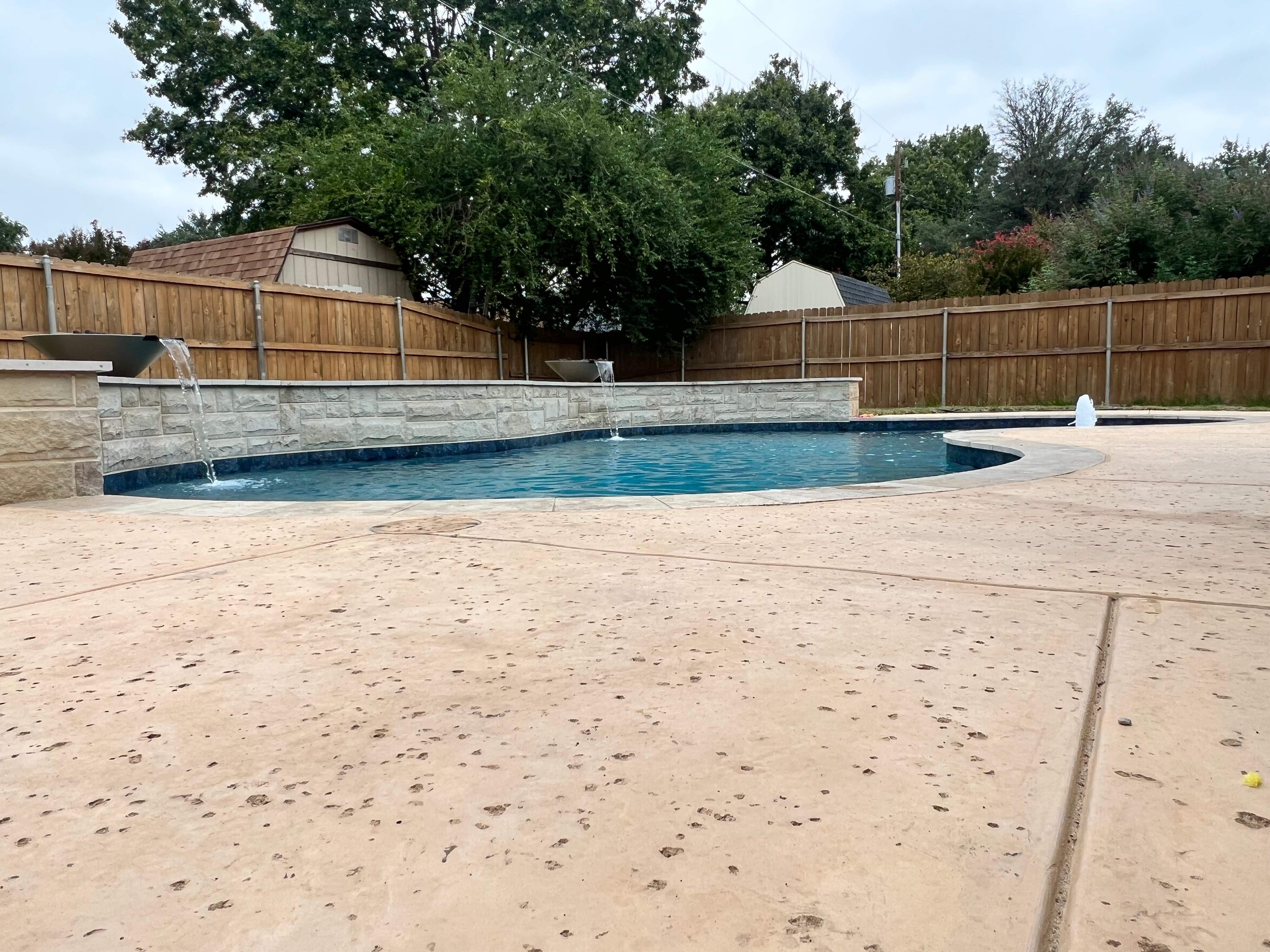 Freeform Pool with Raised Spa and Stone Decking by Pinnacle Pools and Spas - DFW