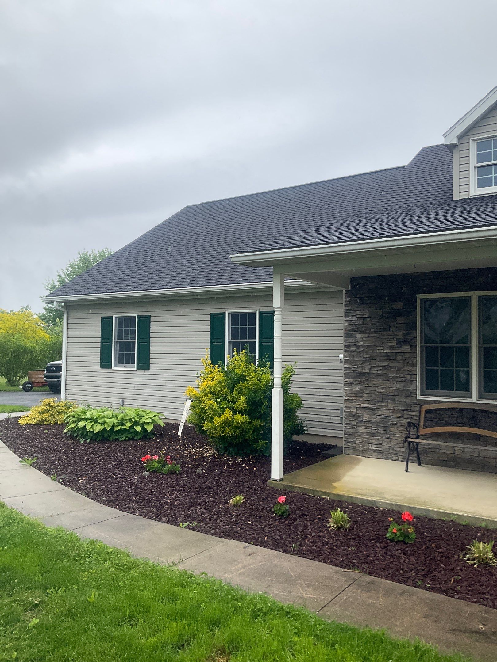 Green Metal Roof and Custom Covered Deck in Duncannon by Esh Builders