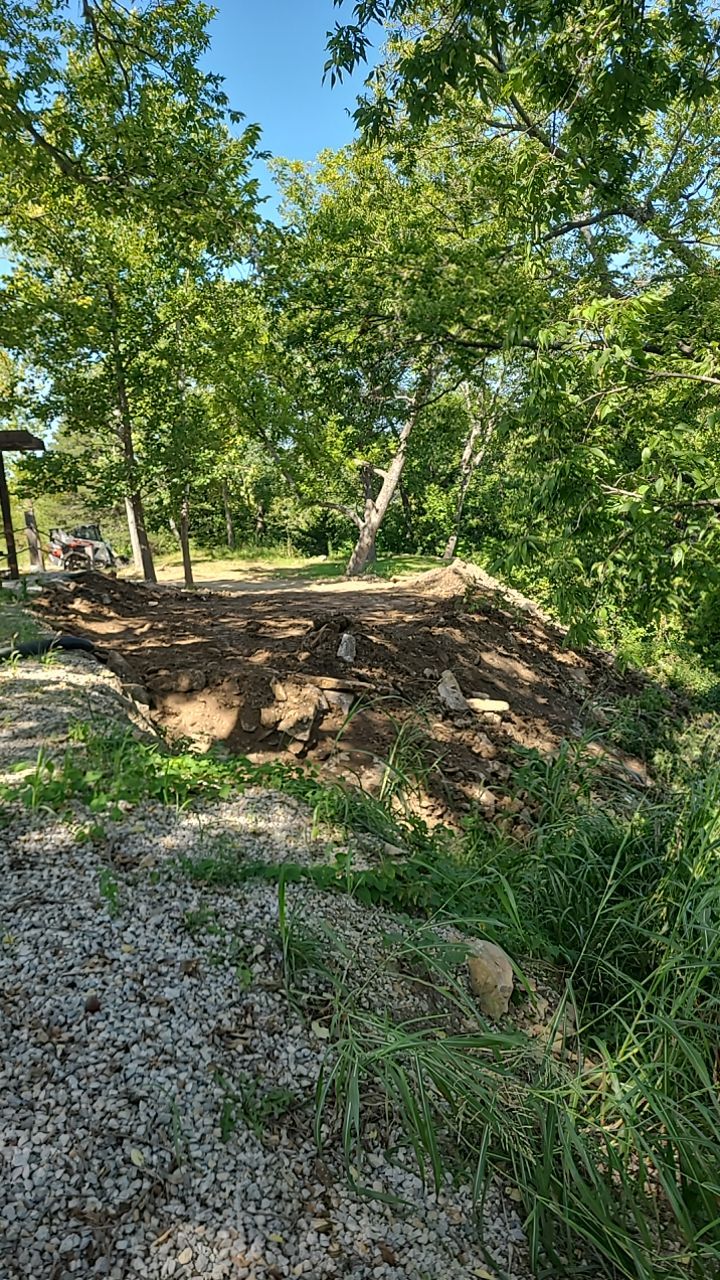 Supporting back of home with backfill at edge of steep creek by LAND ESCAPES LLC