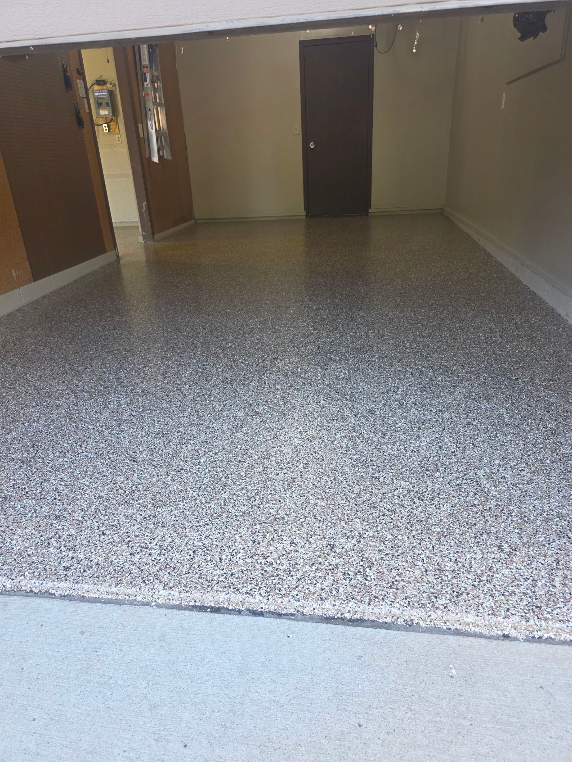 Residential Garage Epoxy Floor Coating Installation in Sioux Falls by Select Painting, Coatings & Garage Cabinets
