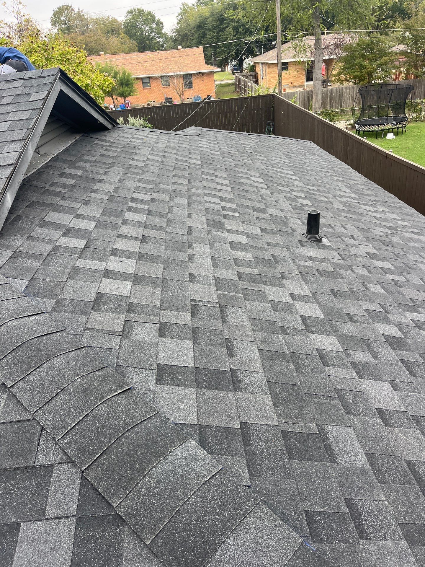 White brick/black accents with IKO Granite Black by Tejas Roofworks + Restoration