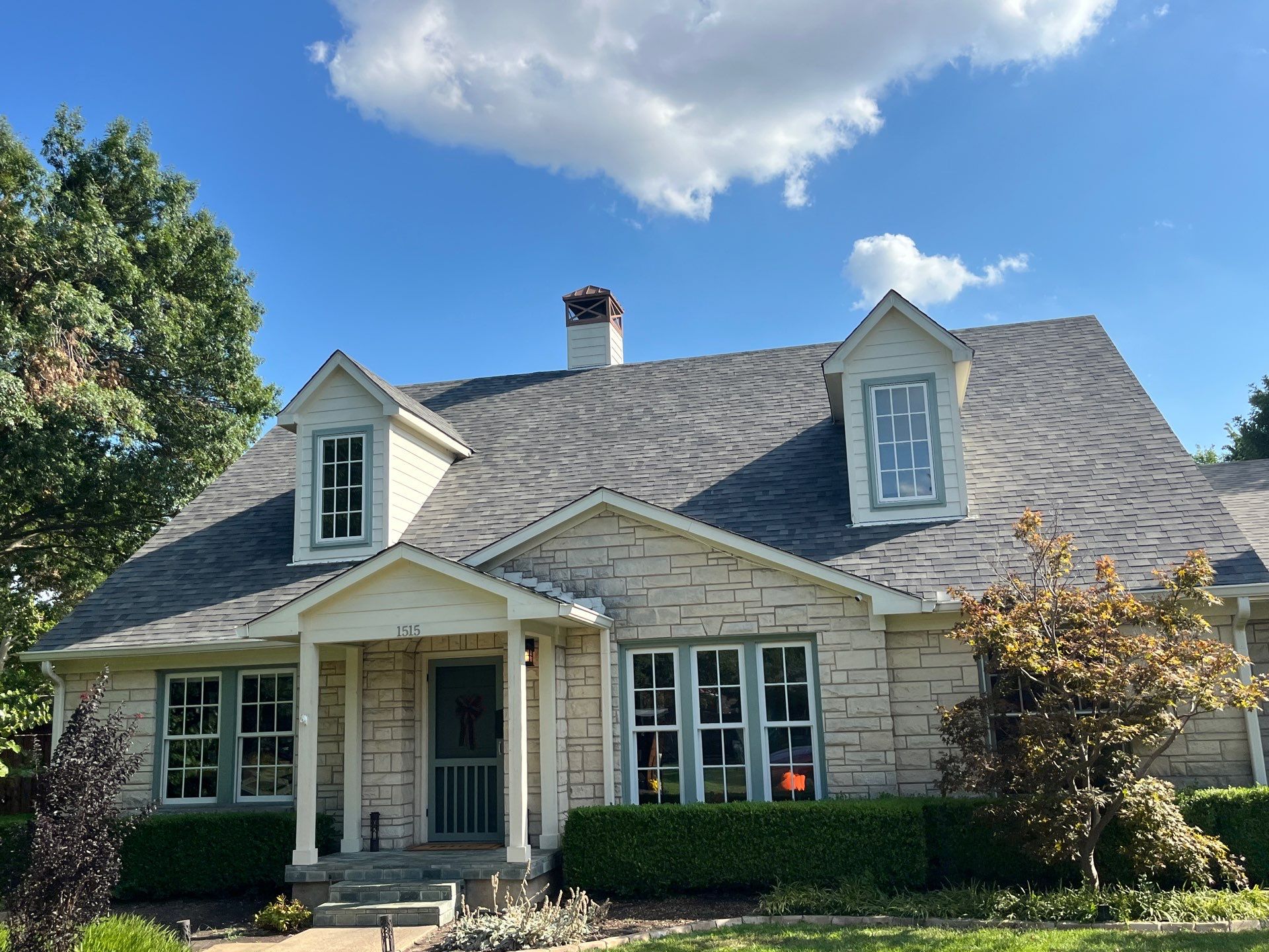 White brick with Malarkey Storm Grey by Tejas Roofworks + Restoration