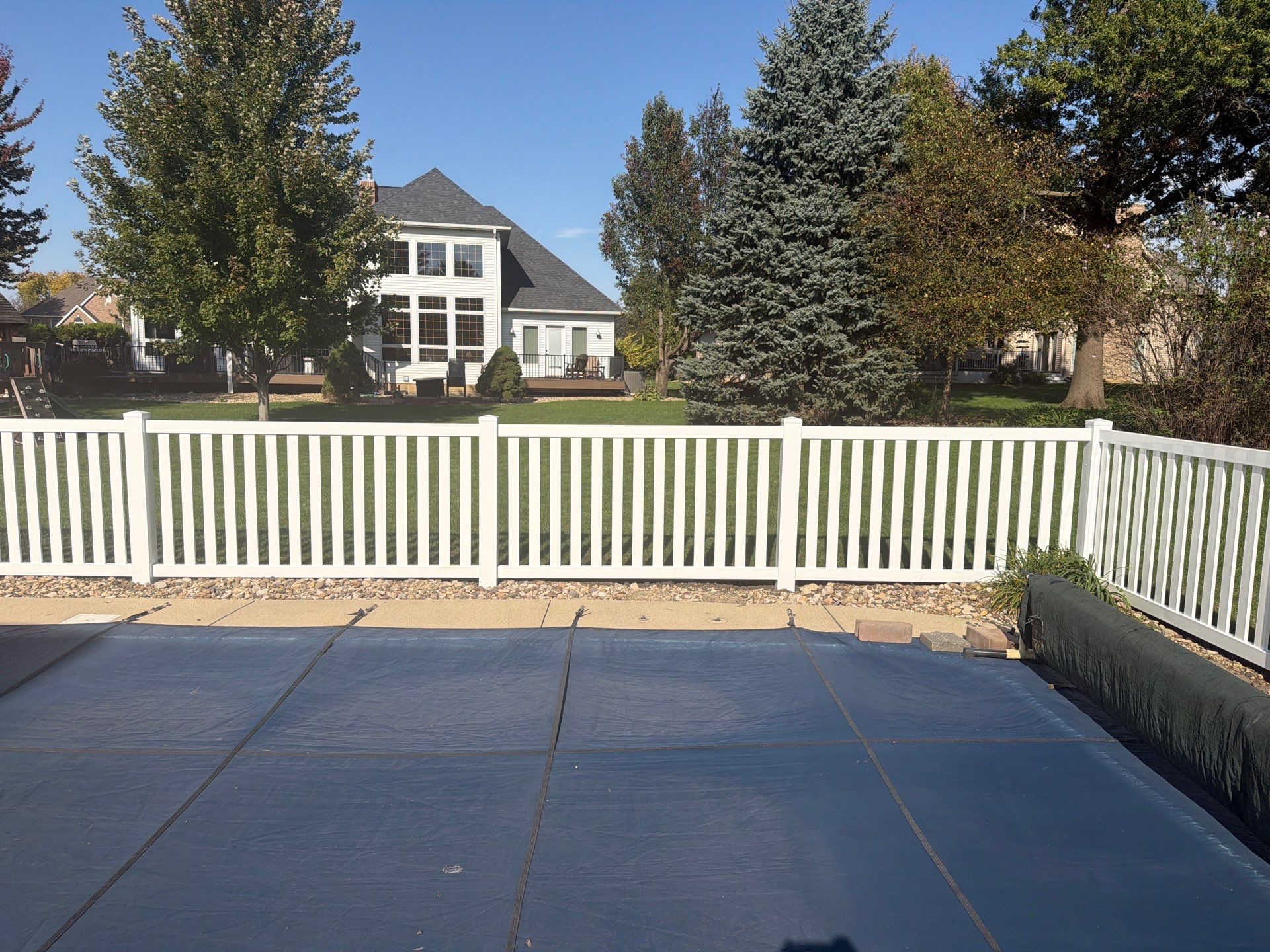 White Vinyl Picket Pool Fence Installation in Waterloo, Iowa by Perfect Picket Fence and Stain