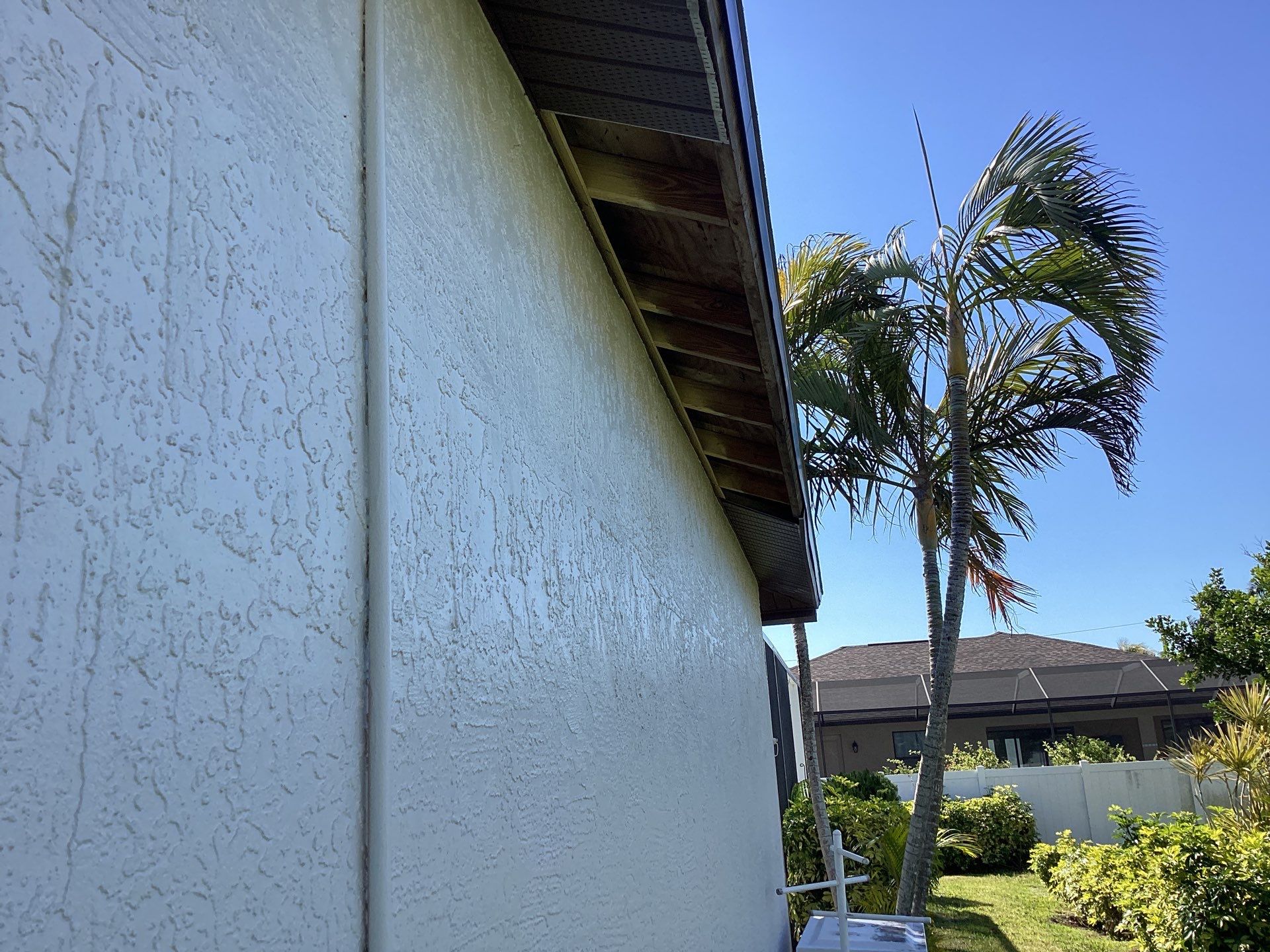 Brown Gutter + White and Brown Downspouts in Cape Coral FL by Gutter Professors