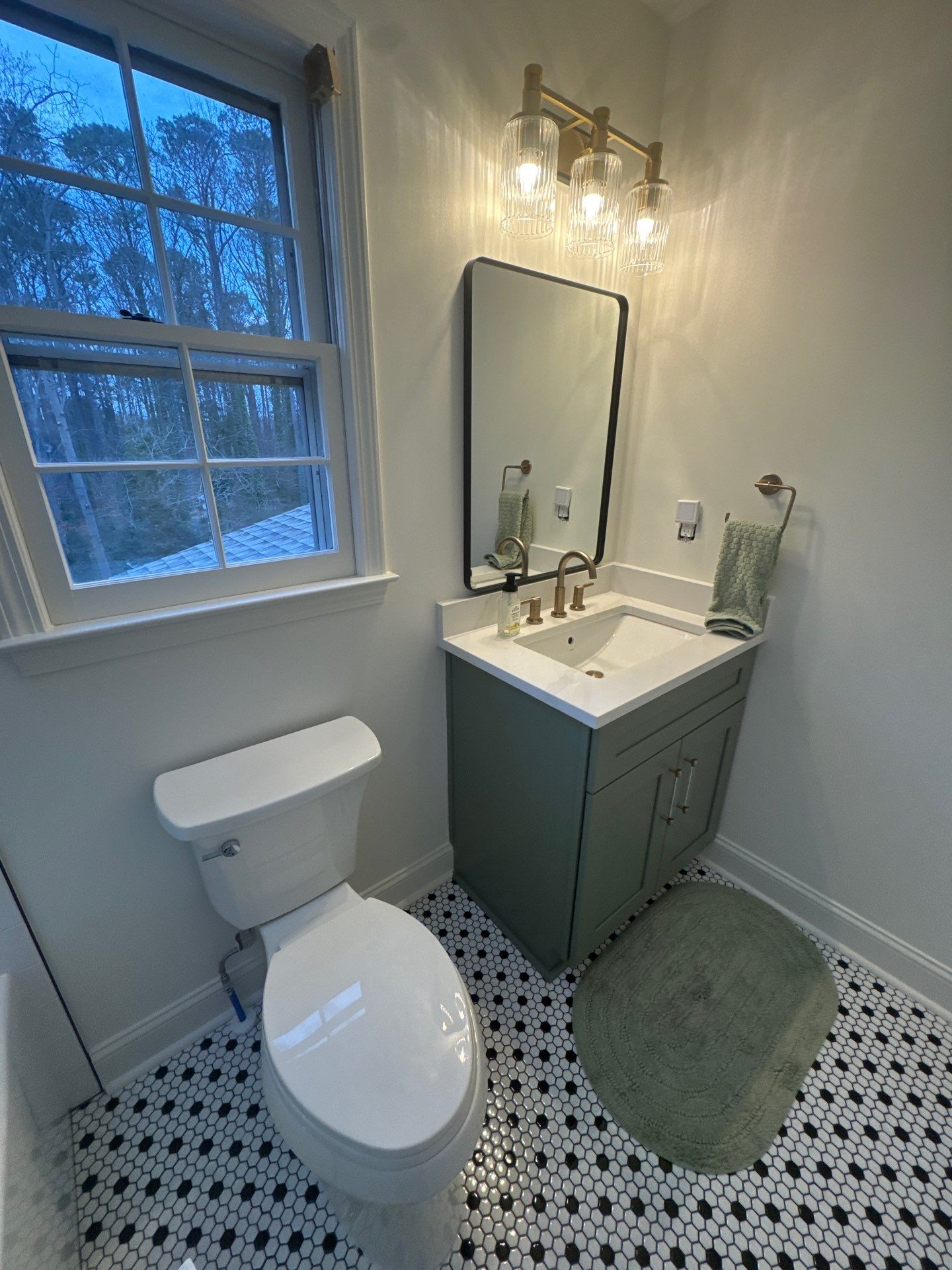 Smyrna Bathroom Remodel Featuring Sage Green Vanity and Hexagonal Tile by Swift Home Renovations