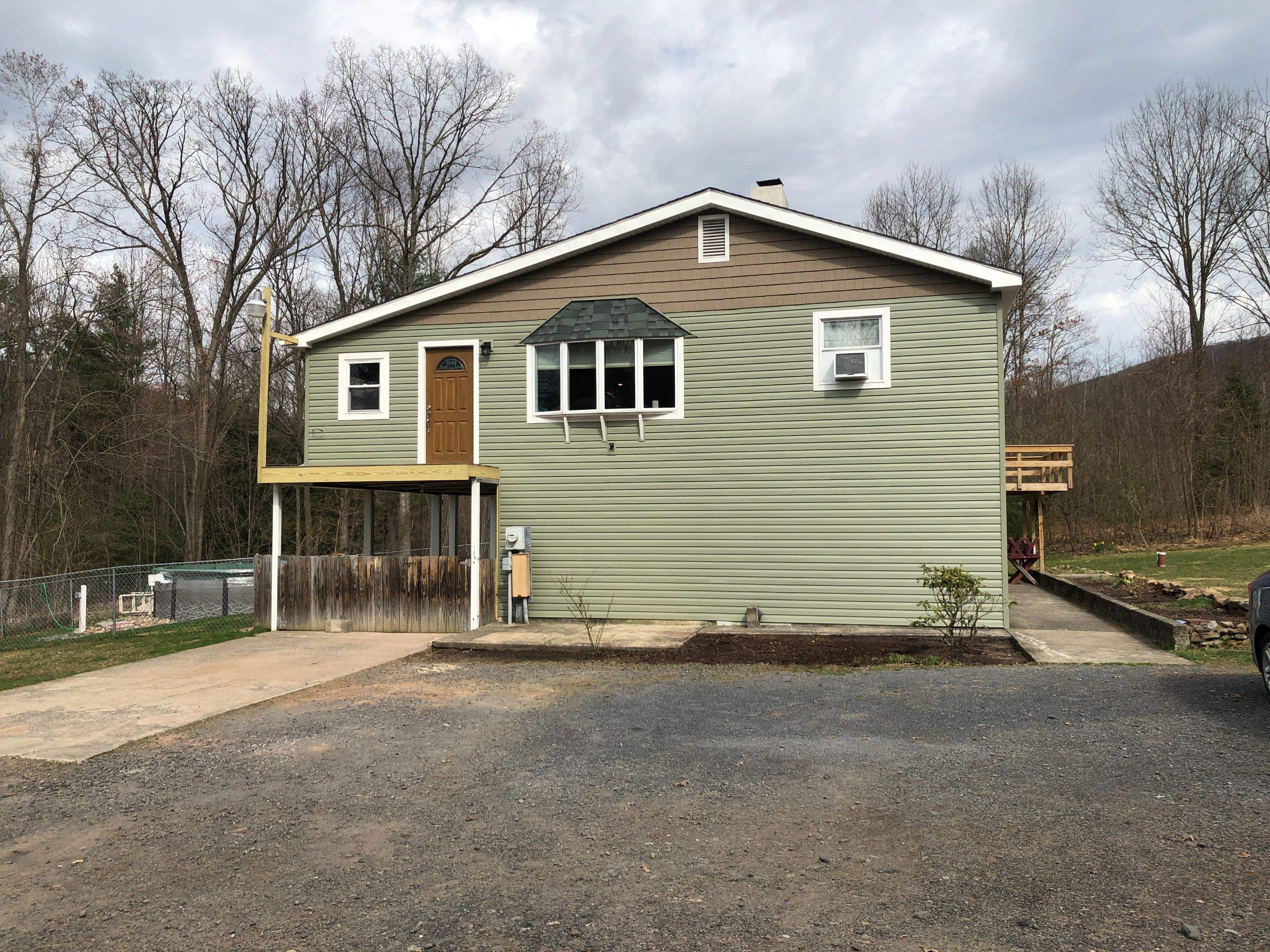 Sage Green Vinyl Siding and Exterior Trim Replacement in Ashland by Esh Builders