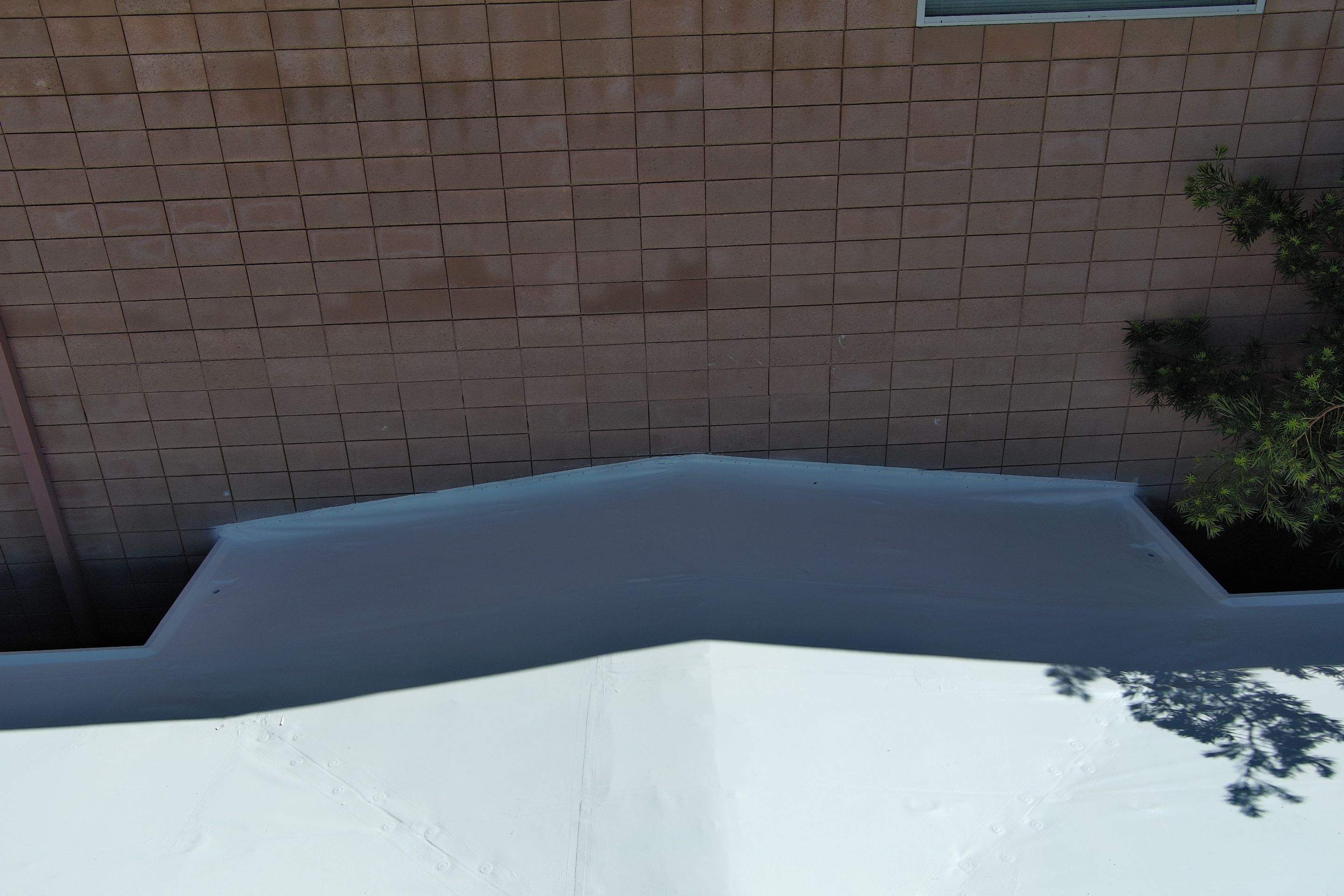 Single-ply restoration system using Benchmark/PUMA XL coatings over TPO single-ply roofing by Straight Edge Roofing Inc