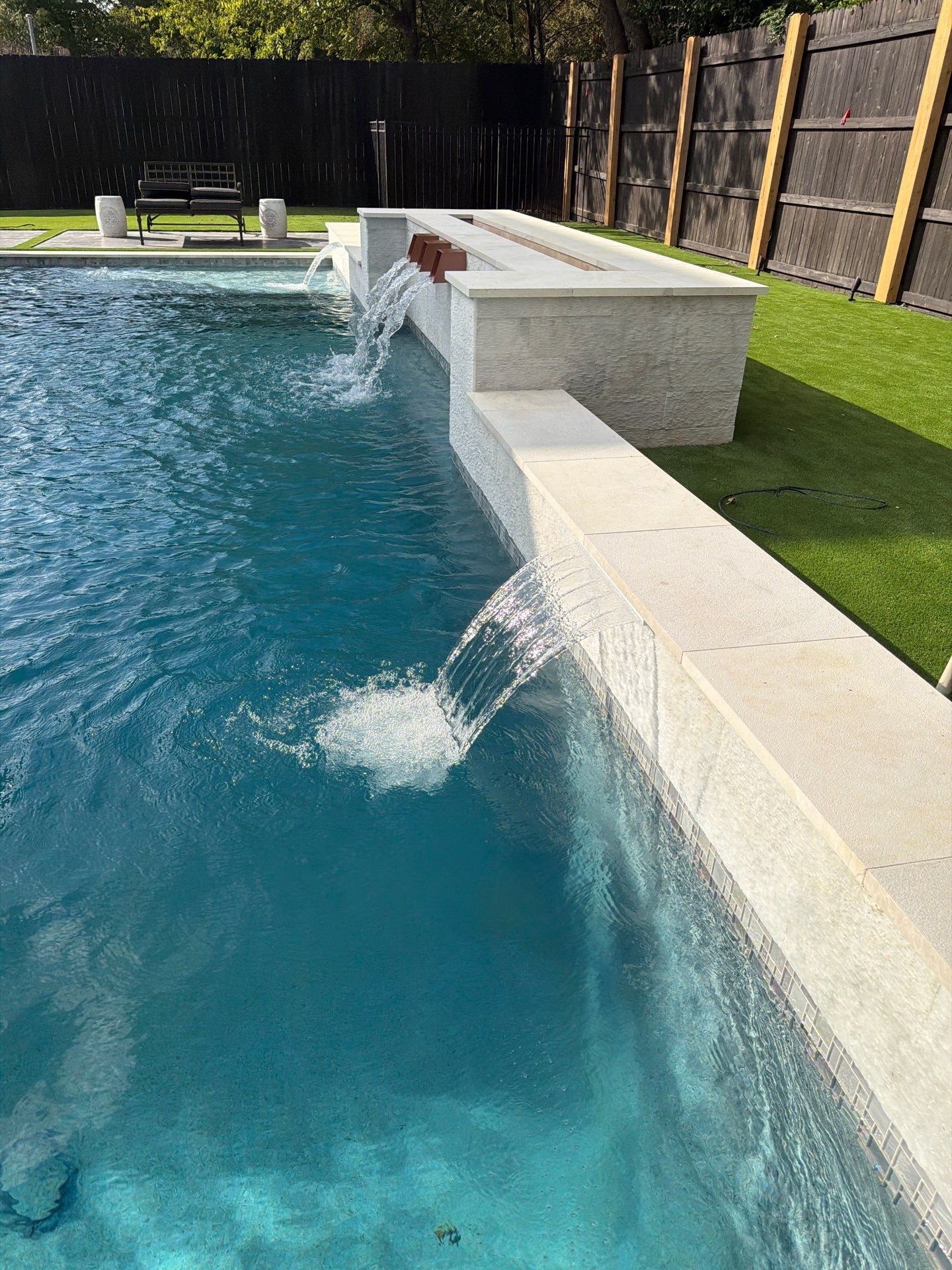 Modern Geometric Pool with Raised Spa and Sheer Descents by Pinnacle Pools and Spas - DFW