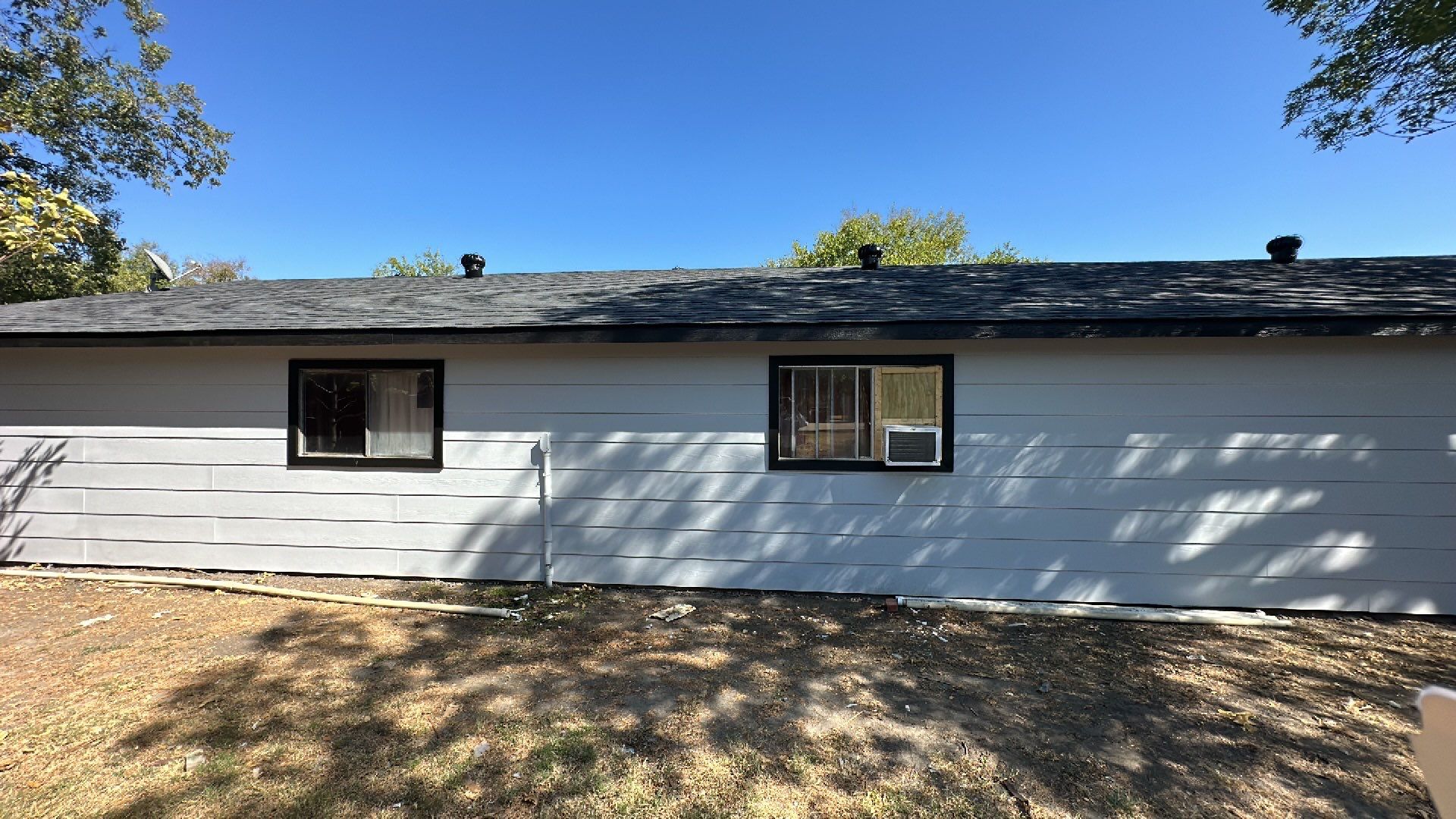 Atlas-Pristine Black with White Siding by Tejas Roofworks + Restoration