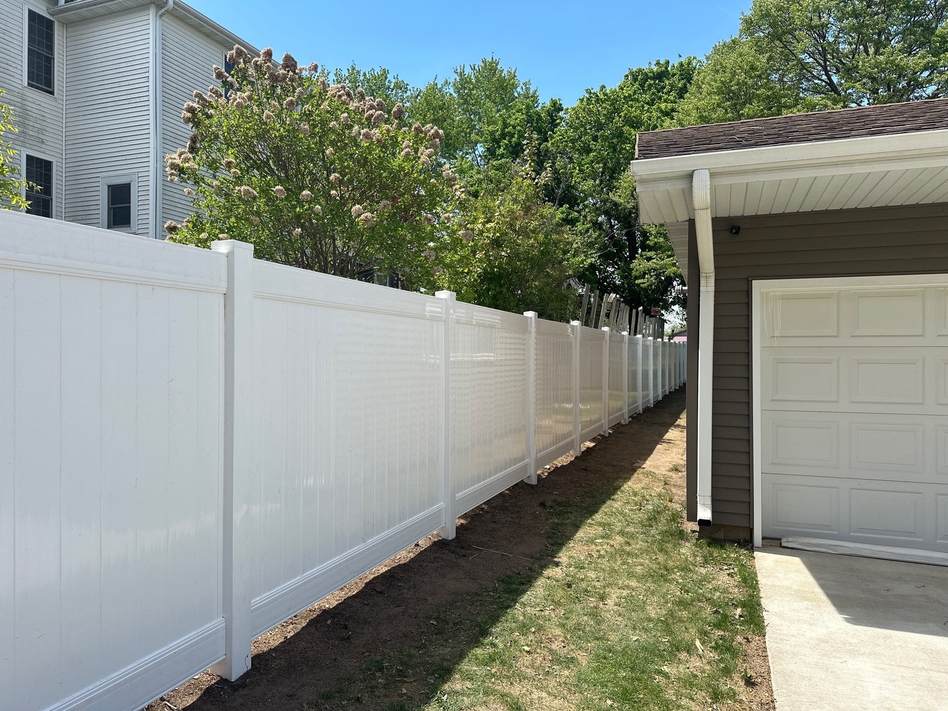 White Vinyl Privacy Fence Installation in Lawler, IA by Perfect Picket Fence and Stain