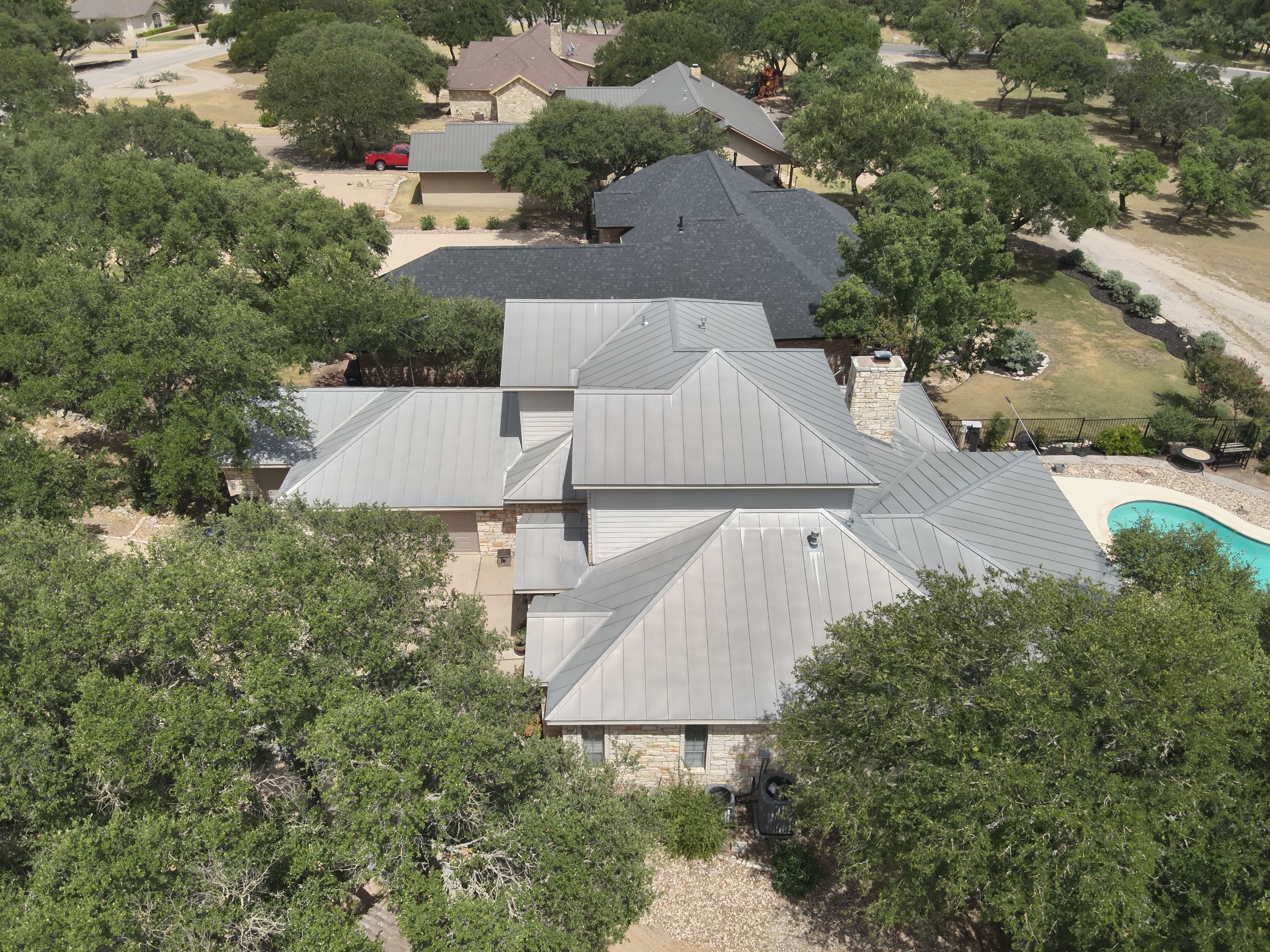 Residential Roof Replacement using 24 GA Double-Lock - Surrey Beige by Action Exteriors Austin