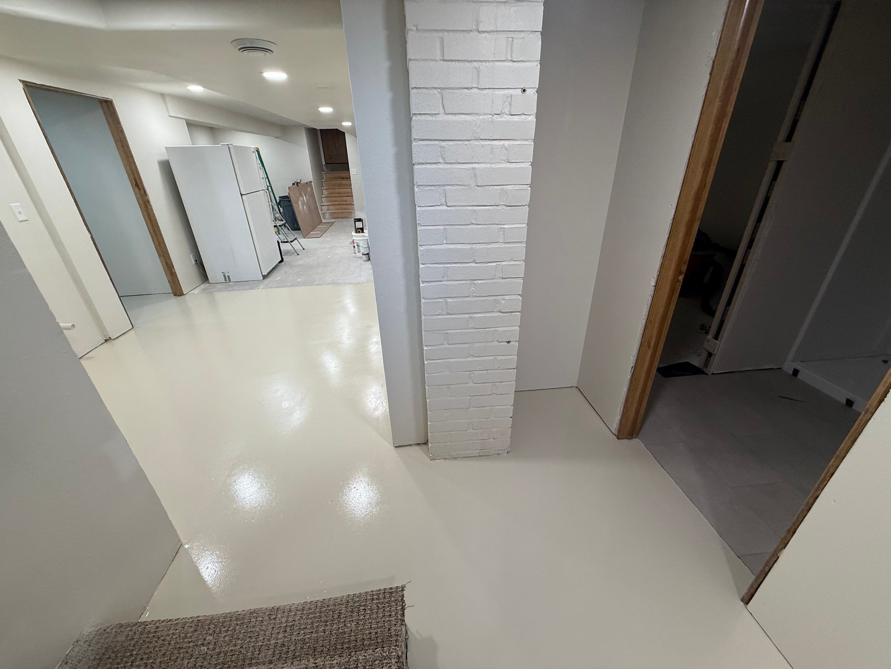 High-Gloss Epoxy Floor Coating and Basement Renovation in Rock Rapids by Select Painting, Coatings & Garage Cabinets