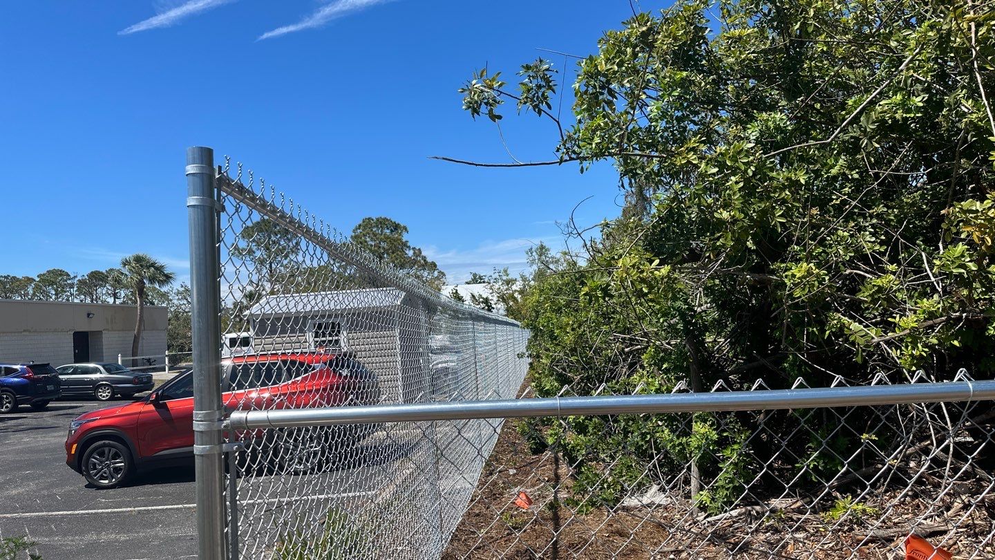 Commercial Chainlink and Vinyl Fence With Aluminum Framed Gates On Dumpster Enclosure by Asap fence and gates, LLC