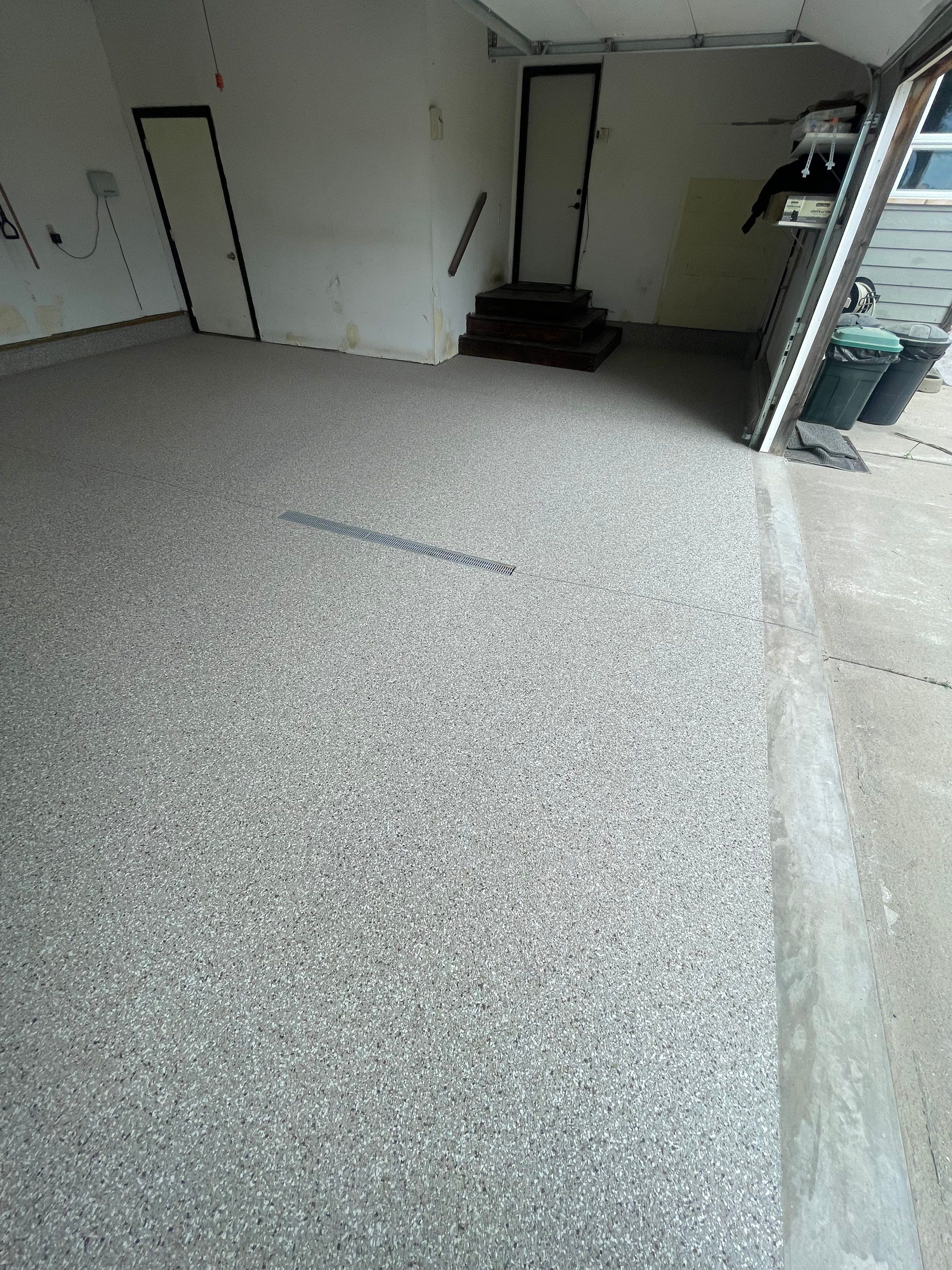 Hartford Residential Garage Floor Transformation With Decorative Chip Coating by Select Painting, Coatings & Garage Cabinets