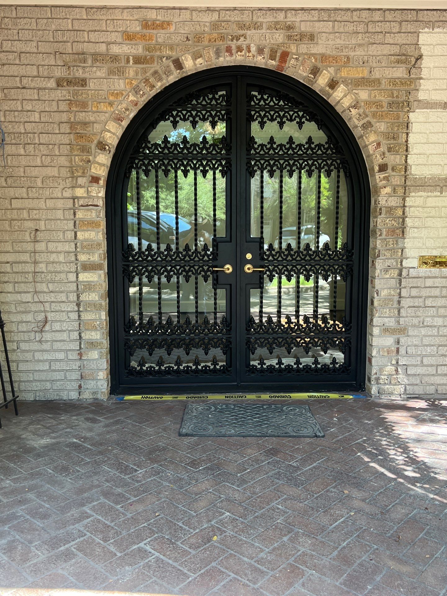 Custom Arched Black Wrought Iron Double Door Installation in Dallas by Solara Custom Living