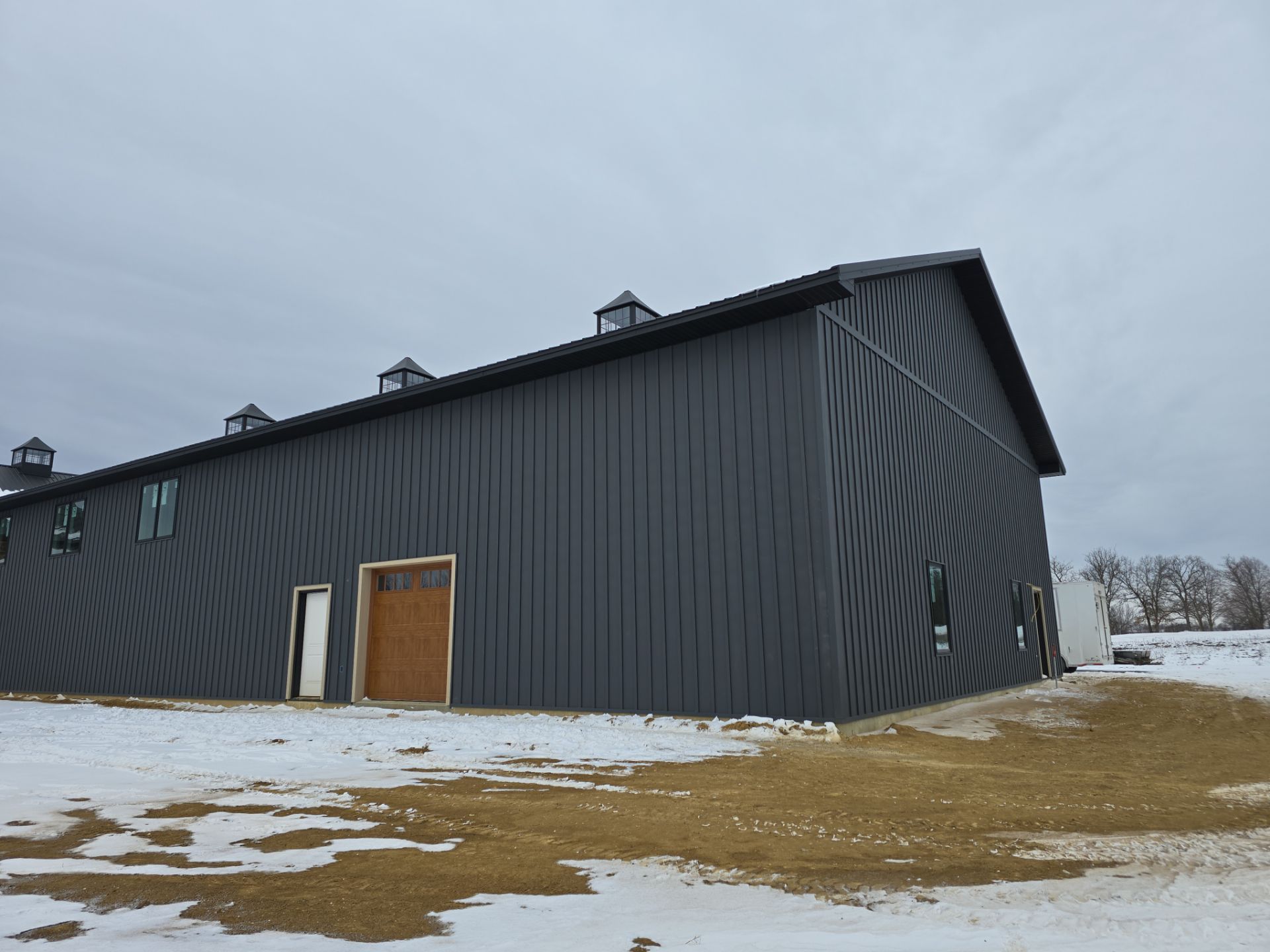 New Home construction w/ board and batten sides and metal roof  by Miles Construction 