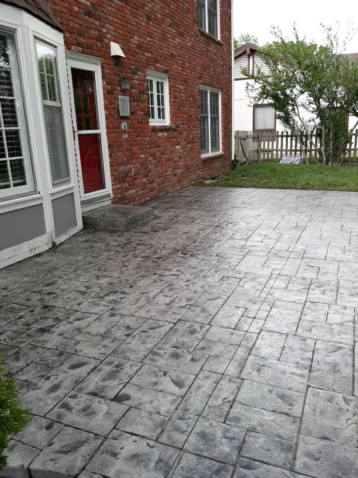 Back Yard Stamped Patio by LAND ESCAPES LLC