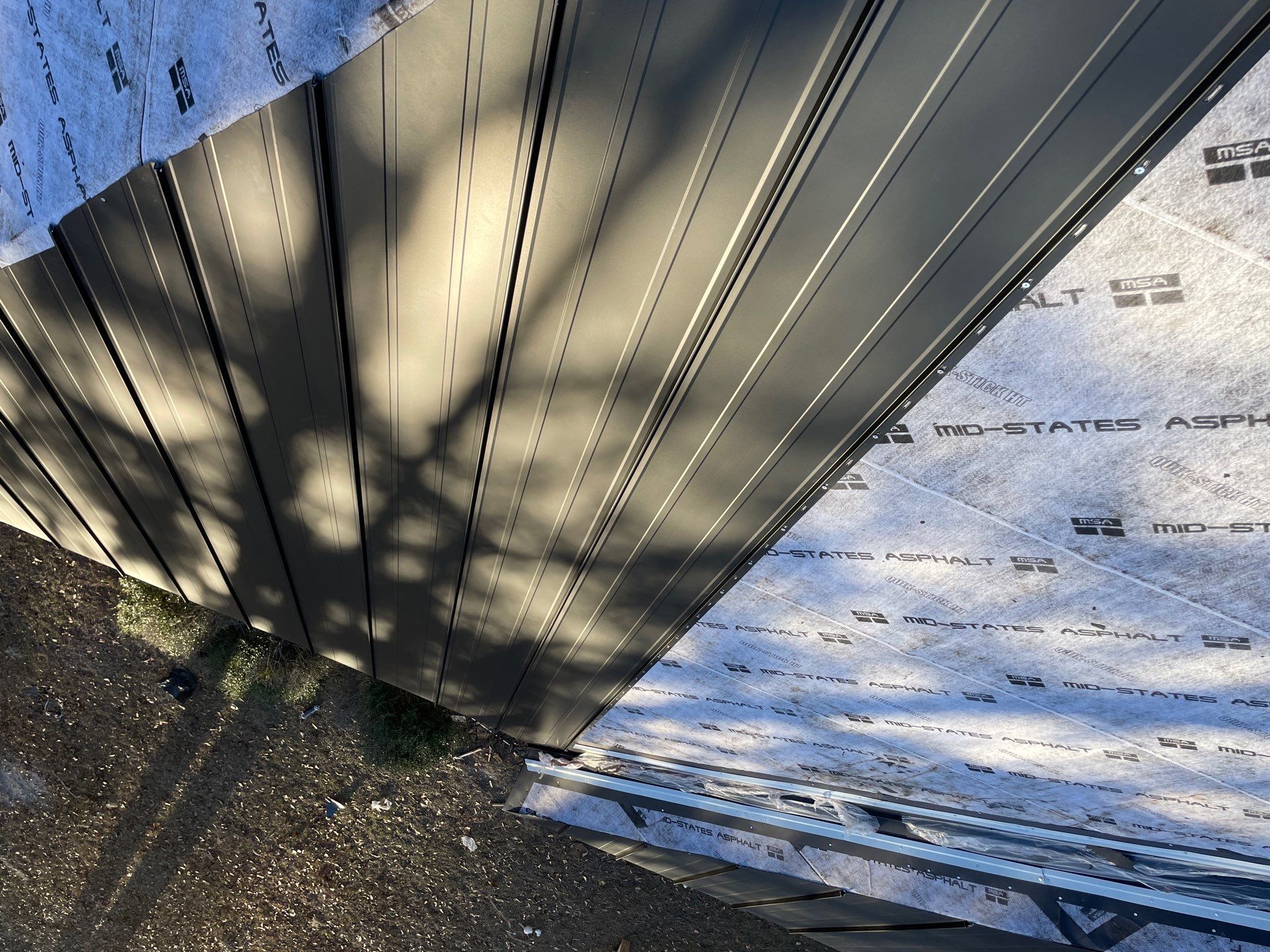 Residential Roofing Installation using Benton 26Ga 1inc Snapcock Metal Roof KYNAR Matte Black by Talya Roofing