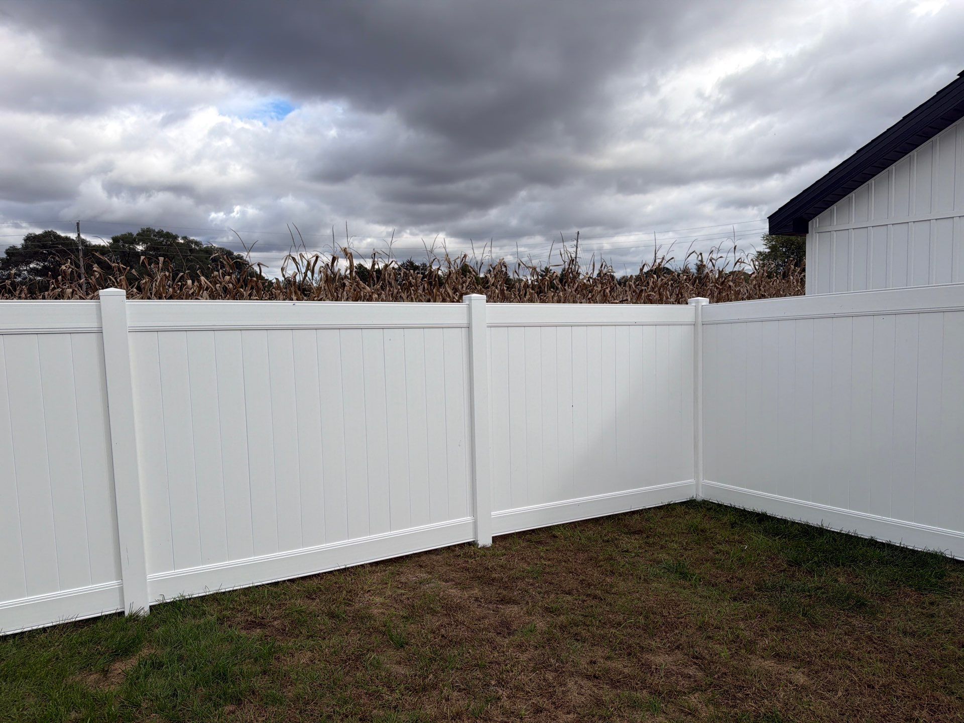 Residential White Vinyl Privacy Fence Installation in Janesville by Perfect Picket Fence and Stain