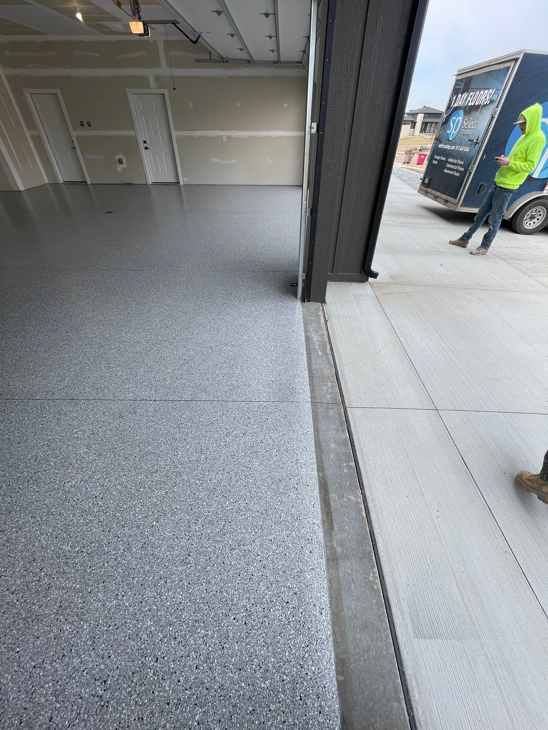 Grey Speckled Epoxy Floor Coating for Sioux Falls Garage by Select Painting, Coatings & Garage Cabinets