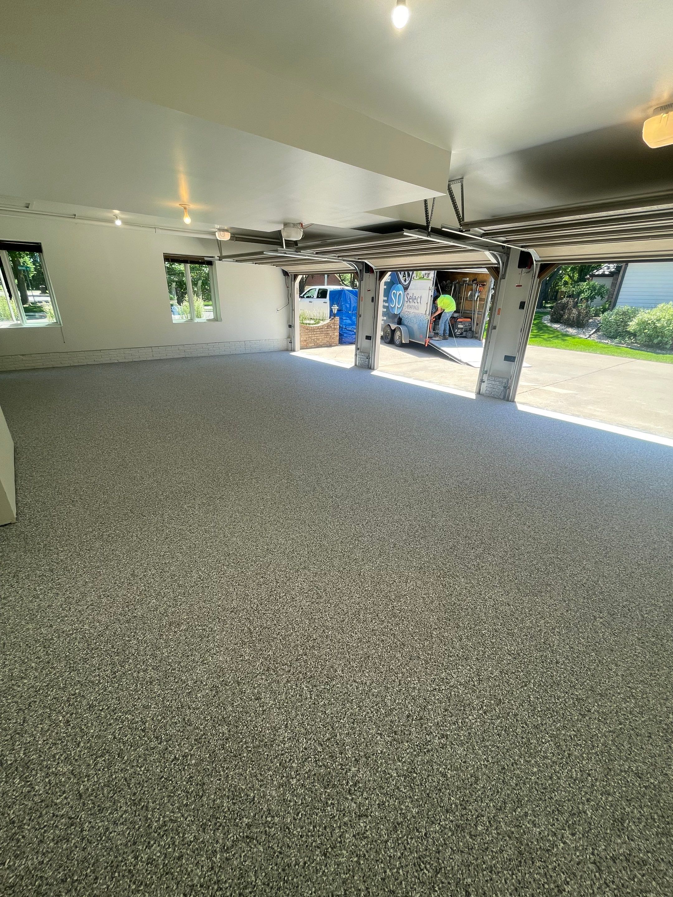 Gray Speckled Epoxy Garage Floor Coating in Sioux Falls by Select Painting, Coatings & Garage Cabinets