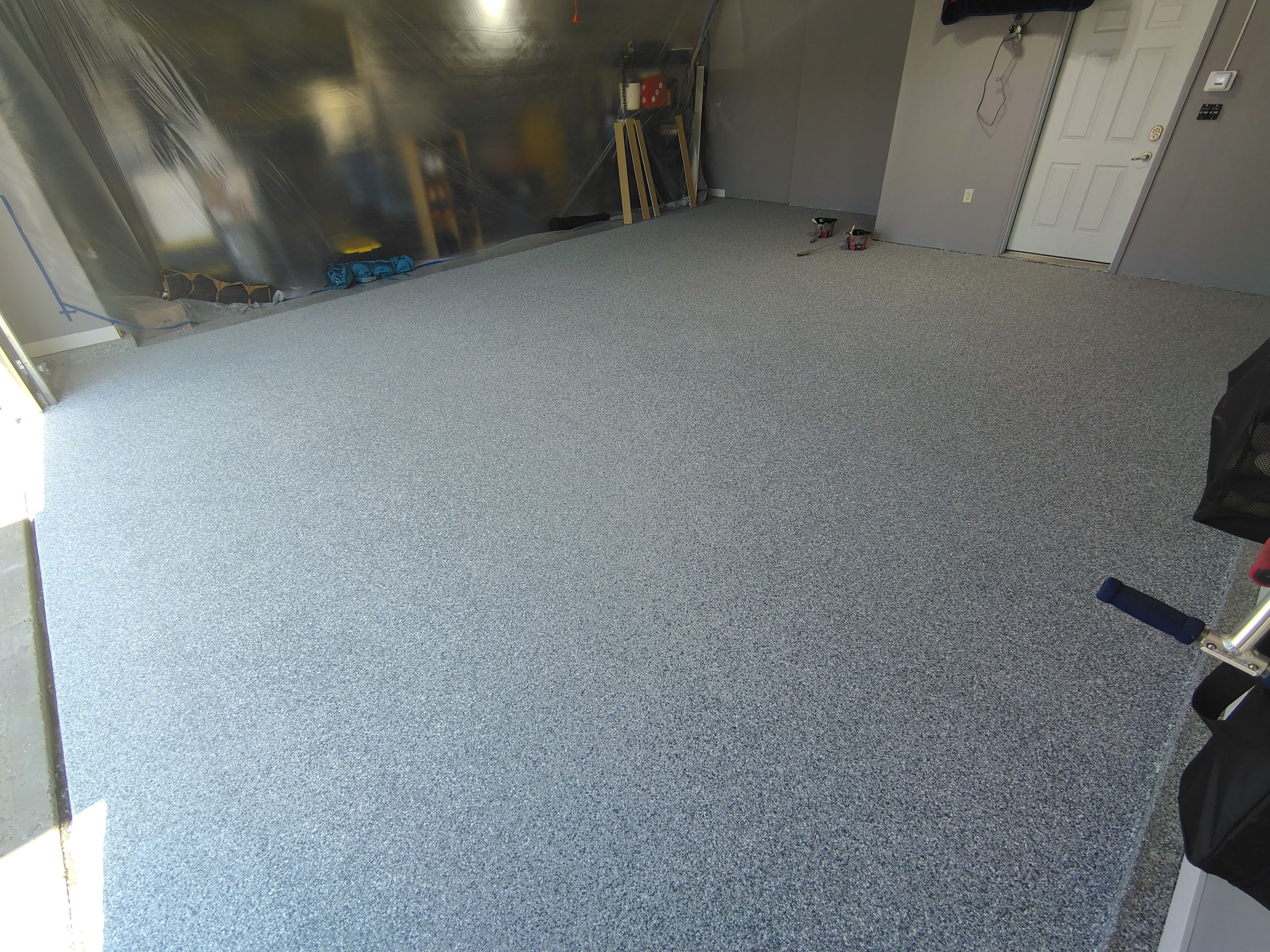 Grey Flecked Epoxy Garage Floor Installation in Sioux Falls by Select Painting, Coatings & Garage Cabinets