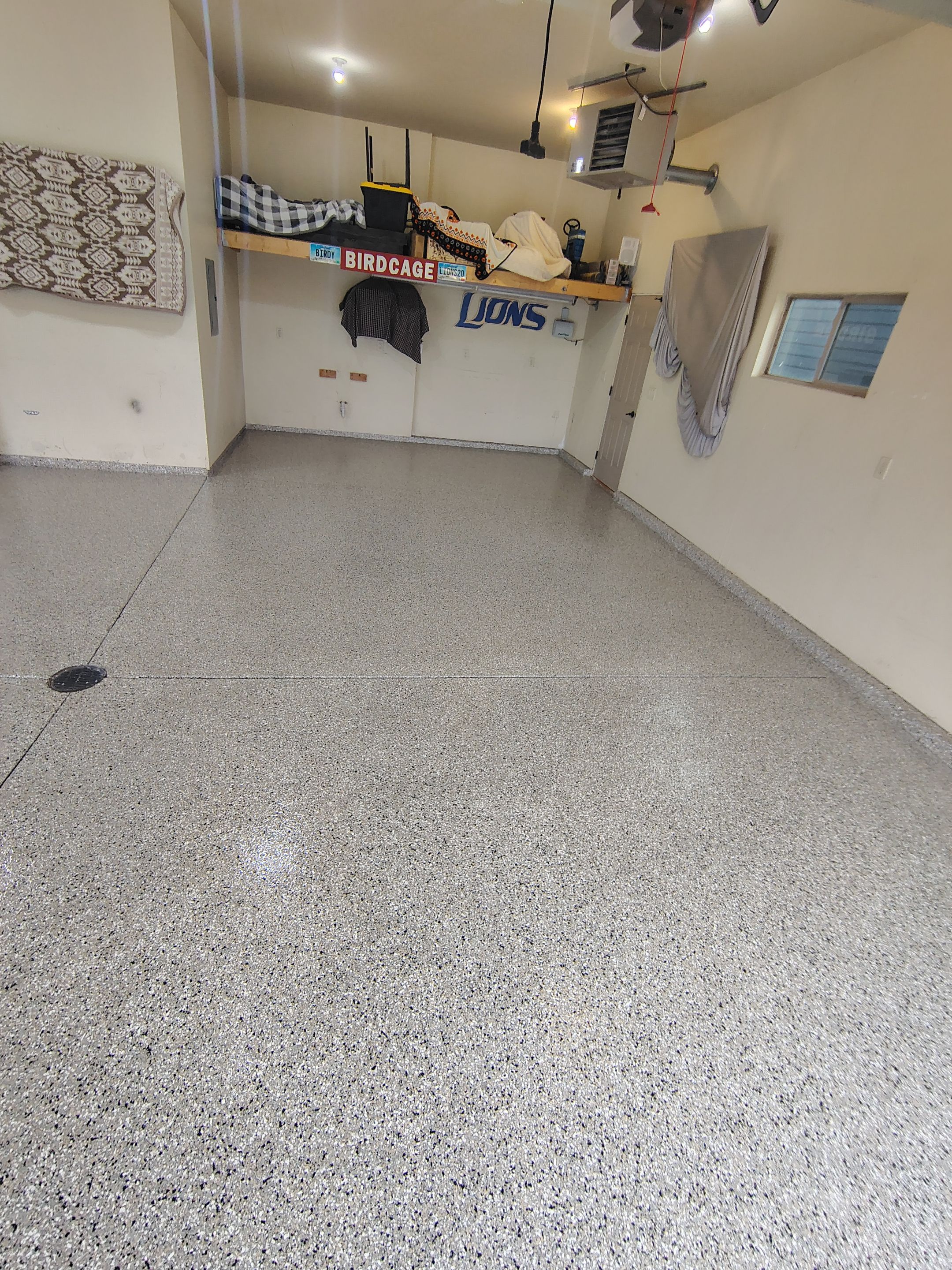 Sioux Falls Garage Floor Repair and Speckled Epoxy Coating Installation by Select Painting, Coatings & Garage Cabinets