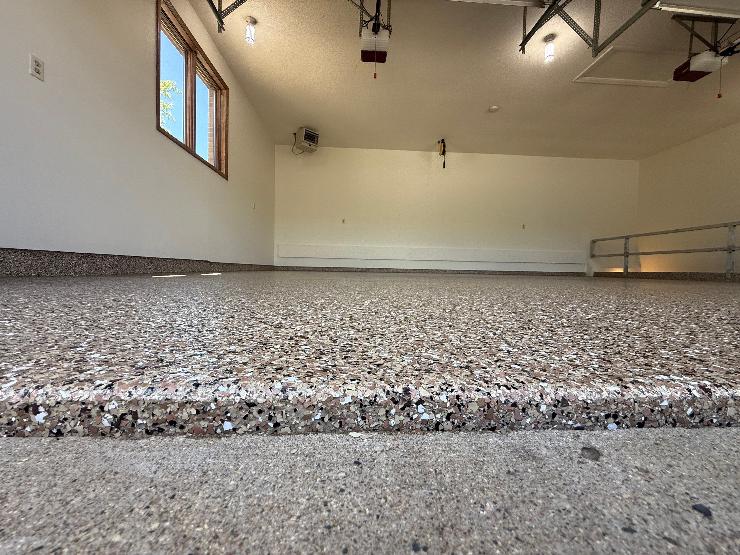 Custom Polyaspartic Garage Floor and Stairwell Coating in Pipestone by Select Painting, Coatings & Garage Cabinets