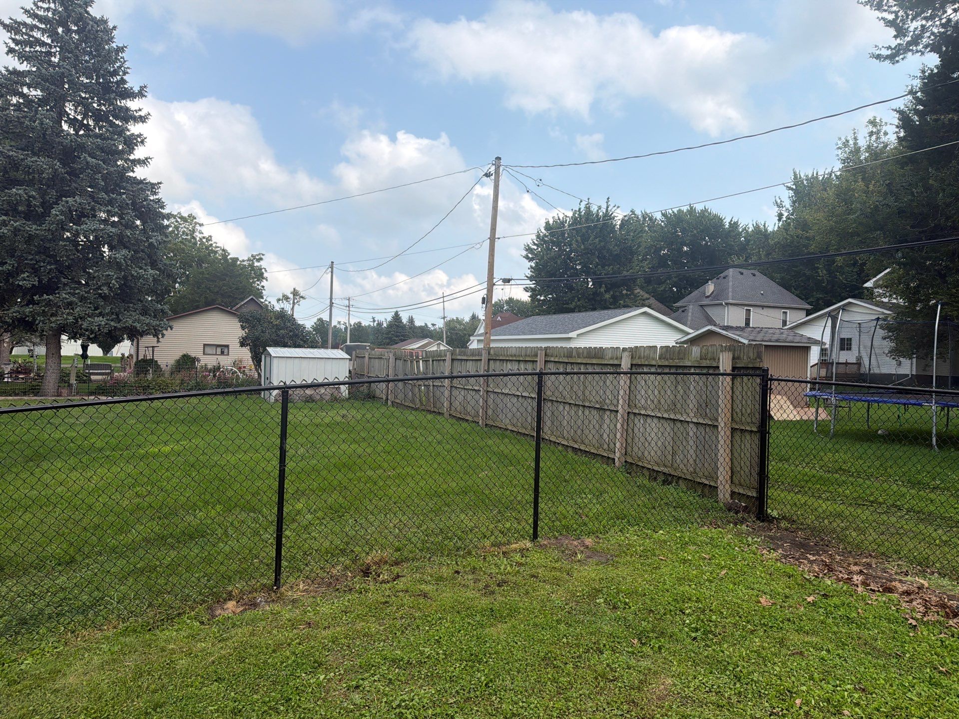 Residential Black Chain Link Fence Installation in Reinbeck by Perfect Picket Fence and Stain