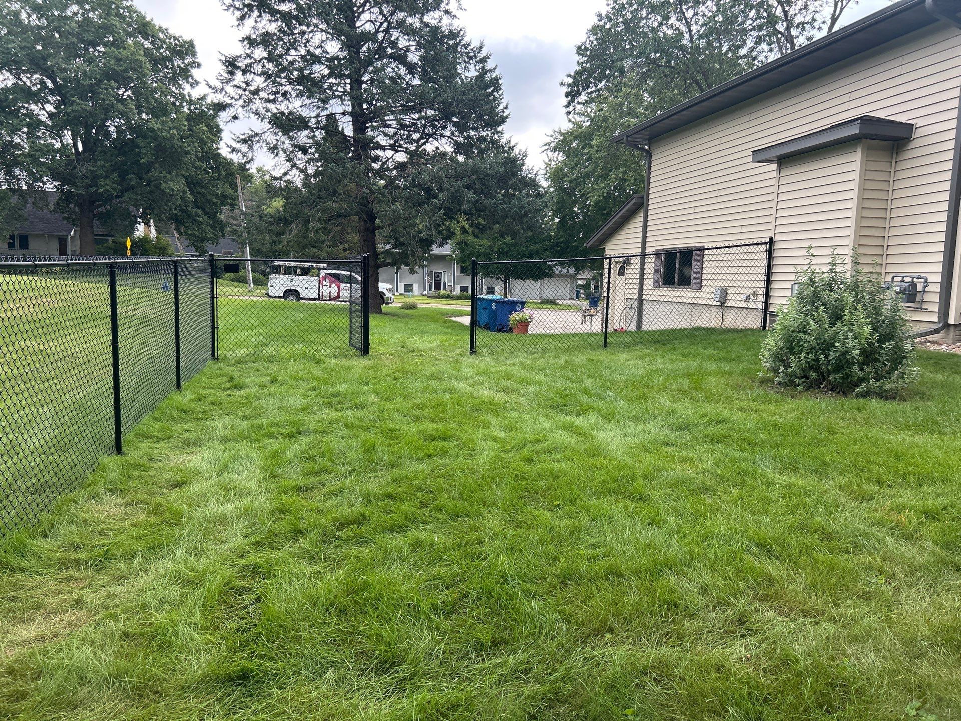 Black Vinyl Coated Chain Link Fence Installation in Waterloo by Perfect Picket Fence and Stain