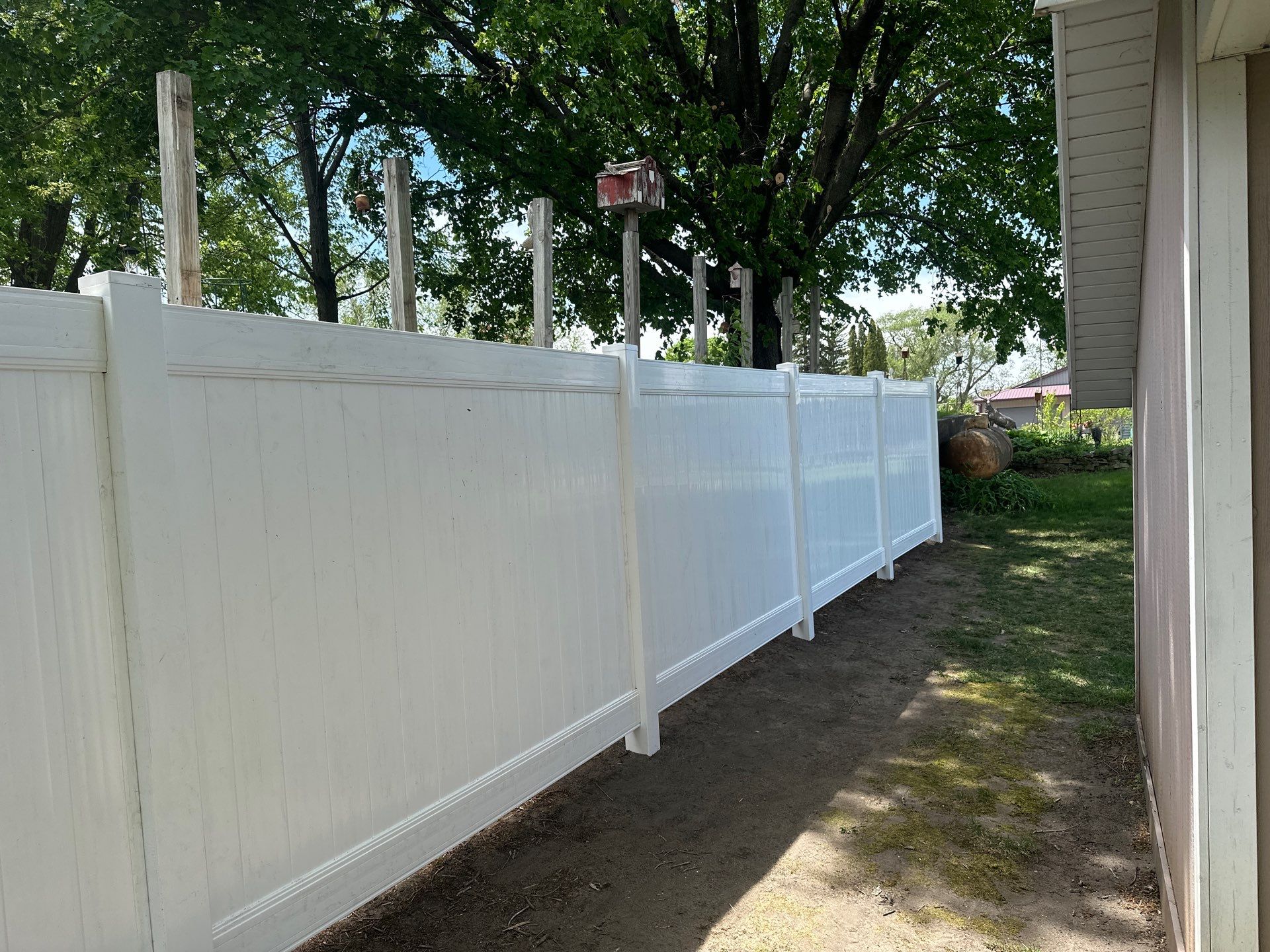 White Vinyl Privacy Fence Installation in Lawler, IA by Perfect Picket Fence and Stain