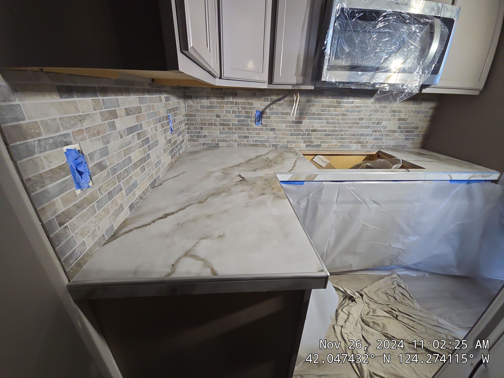 Marble Look Countertop and Stone Tile Backsplash Installation in Brookings by KMD Surfaces INC.